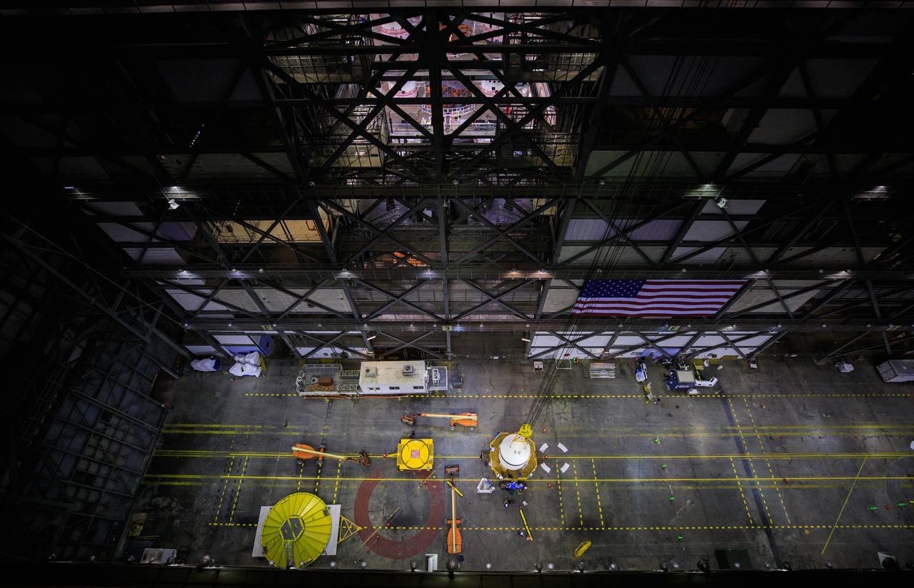 This view from high up in the Vehicle Assembly Building at NASA Kennedy Space Center in Florida, shows a crane lifting the left-hand forward assembly for NASA’s Space Launch System (SLS) in the transfer aisle on March 1, 2021. Workers are lifting the segment up for transfer into High Bay 3, where it will be attached to the center forward segment on the mobile launcher (ML). Exploration Ground Systems and contractor Jacobs teams have been stacking the twin five-segment boosters on the ML over a number of weeks. When the core stage arrives, it will join the boosters on the mobile launcher, followed by the interim cryogenic propulsion stage and Orion spacecraft. Manufactured by Northrop Grumman in Utah, the twin boosters provide more than 75 percent of the total SLS thrust at launch. Marshall Space Flight Center in Huntsville, Alabama, manages the SLS. Under the Artemis program, NASA will land the first woman and the next man on the Moon. The first in a series of increasingly complex missions, Artemis I will test the Orion spacecraft and SLS as an integrated system ahead of crewed flights to the Moon. 