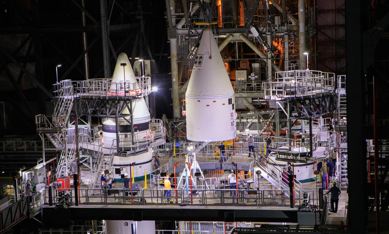 Workers use a crane to lower the right-hand forward assembly for NASA’s Space Launch System onto the right-hand center forward segment on the mobile launcher (ML) in High Bay 3 of the Vehicle Assembly Building at Kennedy Space Center in Florida, on March 2, 2021. Workers with Exploration Ground Systems and contractor Jacobs teams are stacking the twin five-segment boosters on the ML over a number of weeks. When the core stage arrives, it will join the boosters on the mobile launcher, followed by the interim cryogenic propulsion stage and Orion spacecraft. Manufactured by Northrop Grumman in Utah, the twin boosters provide more than 75 percent of the total SLS thrust at launch. Marshall Space Flight Center in Huntsville, Alabama, manages the SLS. Under the Artemis program, NASA will land the first woman and the next man on the Moon. The first in a series of increasingly complex missions, Artemis I will test the Orion spacecraft and SLS as an integrated system ahead of crewed flights to the Moon.
