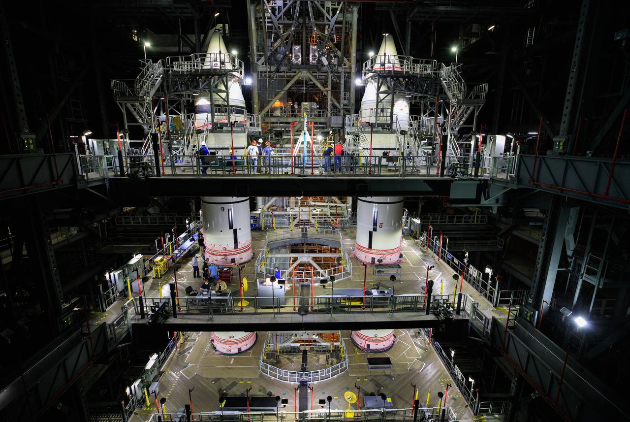 In High Bay 3 of the Vehicle Assembly Building at NASA’s Kennedy Space Center in Florida, the right-hand forward segment is lowered by crane on top of the center forward segment on the mobile launcher (ML) for the Space Launch System (SLS) on March 3, 2021. Workers with Exploration Ground Systems and contractor Jacobs teams are stacking the twin five-segment boosters on the ML over a number of weeks. When the core stage arrives, it will join the boosters on the mobile launcher, followed by the interim cryogenic propulsion stage and Orion spacecraft. Manufactured by Northrop Grumman in Utah, the twin boosters provide more than 75 percent of the total SLS thrust at launch. Marshall Space Flight Center in Huntsville, Alabama, manages the SLS. Under the Artemis program, NASA will land the first woman and the next man on the Moon. The first in a series of increasingly complex missions, Artemis I will test the Orion spacecraft and SLS as an integrated system ahead of crewed flights to the Moon.