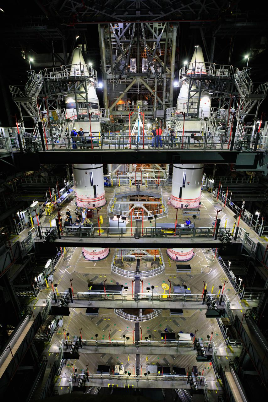 In High Bay 3 of the Vehicle Assembly Building at NASA’s Kennedy Space Center in Florida, right-hand and left-hand forward segments are secured on top of the center forward segments on the mobile launcher (ML) for the Space Launch System (SLS) on March 3, 2021. Workers with Exploration Ground Systems and contractor Jacobs teams completed the stacking of the boosters over several weeks. When the core stage arrives, it will join the boosters on the ML, followed by the interim cryogenic propulsion stage and Orion spacecraft. Manufactured by Northrop Grumman in Utah, the twin boosters provide more than 75 percent of the total SLS thrust at launch. Marshall Space Flight Center in Huntsville, Alabama, manages the SLS. Under the Artemis program, NASA will land the first woman and the next man on the Moon. The first in a series of increasingly complex missions, Artemis I will test the Orion spacecraft and SLS as an integrated system ahead of crewed flights to the Moon.