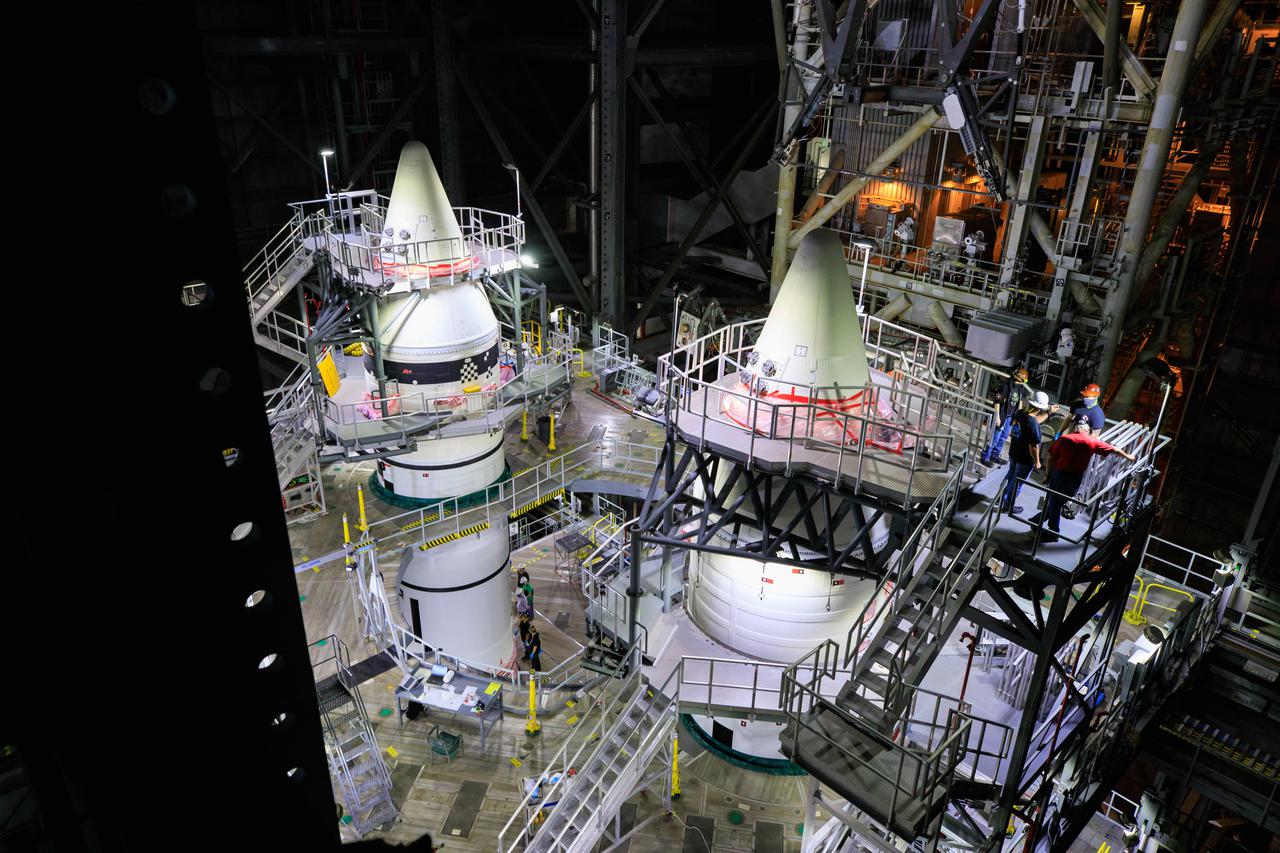 In a view high above in High Bay 3 of the Vehicle Assembly Building at NASA’s Kennedy Space Center in Florida, the right-hand and left-hand forward segments are secured on the center forward segments on the mobile launcher (ML) for the Space Launch System (SLS) on March 3, 2021. Workers with Exploration Ground Systems and contractor Jacobs teams stacked the twin five-segment boosters on the ML over a number of weeks. When the core stage arrives, it will join the boosters on the mobile launcher, followed by the interim cryogenic propulsion stage and Orion spacecraft. Manufactured by Northrop Grumman in Utah, the twin boosters provide more than 75 percent of the total SLS thrust at launch. Marshall Space Flight Center in Huntsville, Alabama, manages the SLS. Under the Artemis program, NASA will land the first woman and the next man on the Moon. The first in a series of increasingly complex missions, Artemis I will test the Orion spacecraft and SLS as an integrated system ahead of crewed flights to the Moon.