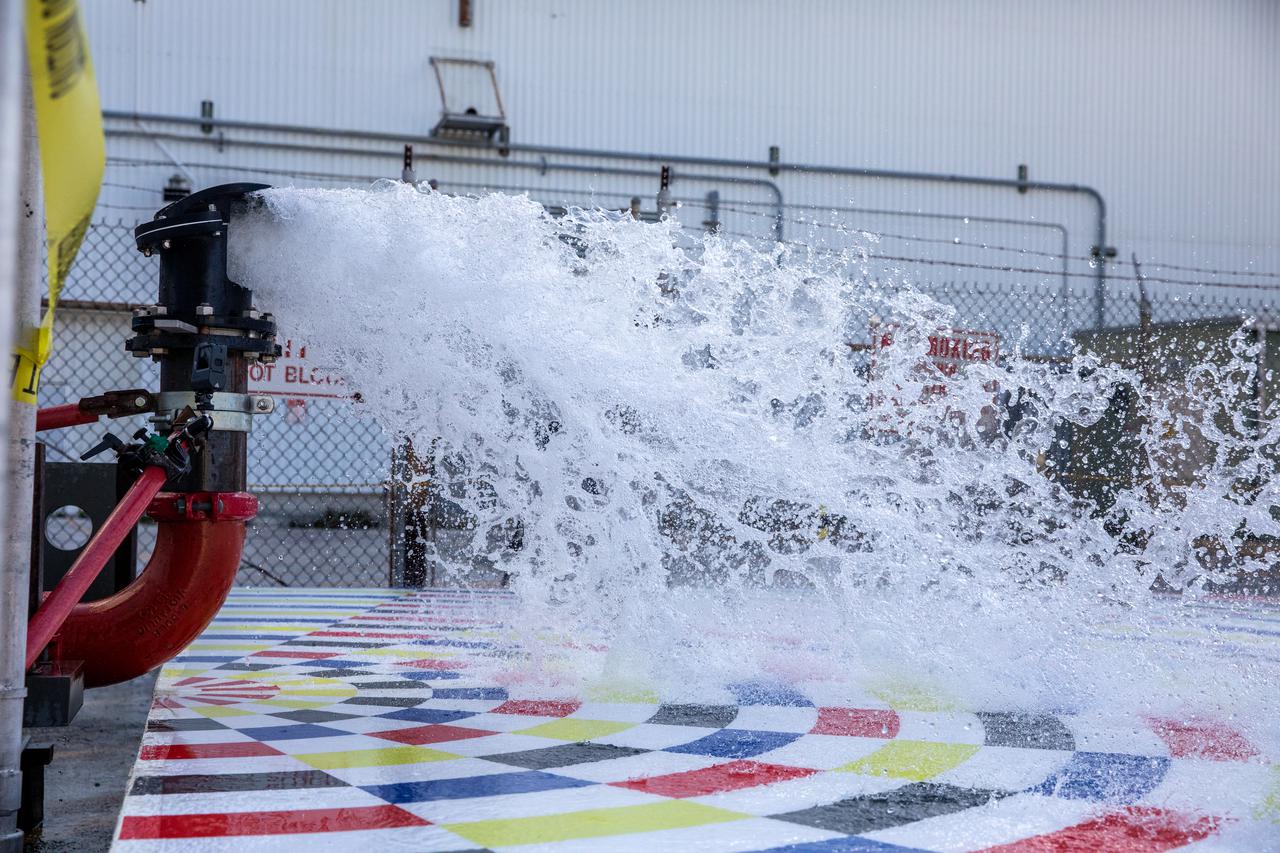 Water flows through a small-scale, 3D-printed nozzle during prototype testing of a new rainbird system on March 24, 2021, at NASA’s Kennedy Space Center in Florida. Rainbirds are large water nozzles located on the mobile launcher (ML) that release a high volume of water when the Space Launch System (SLS) rocket lifts off, protecting the vehicle, launch pad, and ML by absorbing some of the heat and energy generated during launch. The test involved running various water pressures through smaller nozzles to capture data that can be used to develop full-scale replacement nozzles for future missions under the Artemis program.