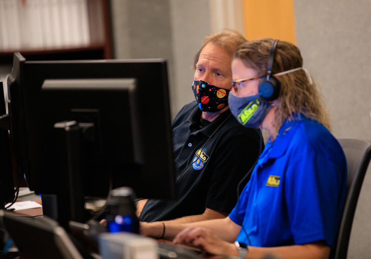 Janine Captain, at right, principal investigator for NASA’s Mass Spectrometer observing lunar operations (MSolo) and Kevin Smith, software team and science team liaison at NASA’s Kennedy Space Center in Florida, confer during a joint simulation of the Peregrine One Mission on March 26, 2021, where MSolo is connected from inside the Neil Armstrong Operations and Checkout Building to Astrobotic’s mission control facility in Pittsburgh, Pennsylvania. MSolo is a commercial off-the-shelf mass spectrometer modified to work in space and it will help analyze the chemical makeup of landing sites on the Moon, as well as study water on the lunar surface. This was the first mission round of simulations for Peregrine Mission One to develop and refine procedures between Astrobotic’s Peregrine Lander and MSolo. Later, there will be other simulations with multiple instruments. Peregrine Mission One will be one of NASA’s first Commercial Lunar Payload Delivery Service (CLPS) missions where under the Artemis program, commercial deliveries beginning in 2021 will perform science experiments, test technologies and demonstrate capabilities to help NASA explore the Moon and prepare for human missions.