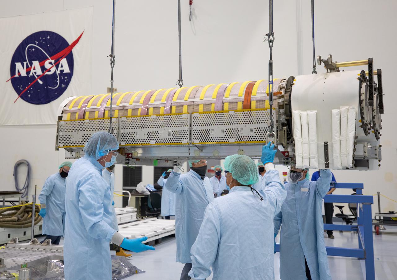 NASA and Boeing workers lift solar arrays into flight support equipment on April 2, 2021, in the Space Station Processing Facility at NASA’s Kennedy Space Center in Florida. The 63- by- 20-foot solar arrays will launch to the International Space Station later this year. They are the first two of six new solar arrays that in total will produce more than 120 kilowatts of electricity from the Sun’s energy, enough to power more than 40 average U.S. homes. Combined with the eight original, larger arrays, this advanced hardware will provide 215 kilowatts of energy, a 20 to 30 percent increase in power, helping maximize the space station’s capabilities for years to come. The arrays will produce electricity to sustain the station’s systems and equipment, plus augment the electricity available to continue a wide variety of public and private experiments and research in the microgravity environment of low-Earth orbit. Most of the station systems, including its batteries, scientific equipment racks, and communications equipment have been upgraded since humans began a continuous presence on the orbiting laboratory in November 2000. For more than two decades, astronauts have lived and worked on this unique orbiting lab, supporting scientific research that has led to numerous discoveries that benefit people on Earth and prepare for future Artemis missions to the Moon and beyond.