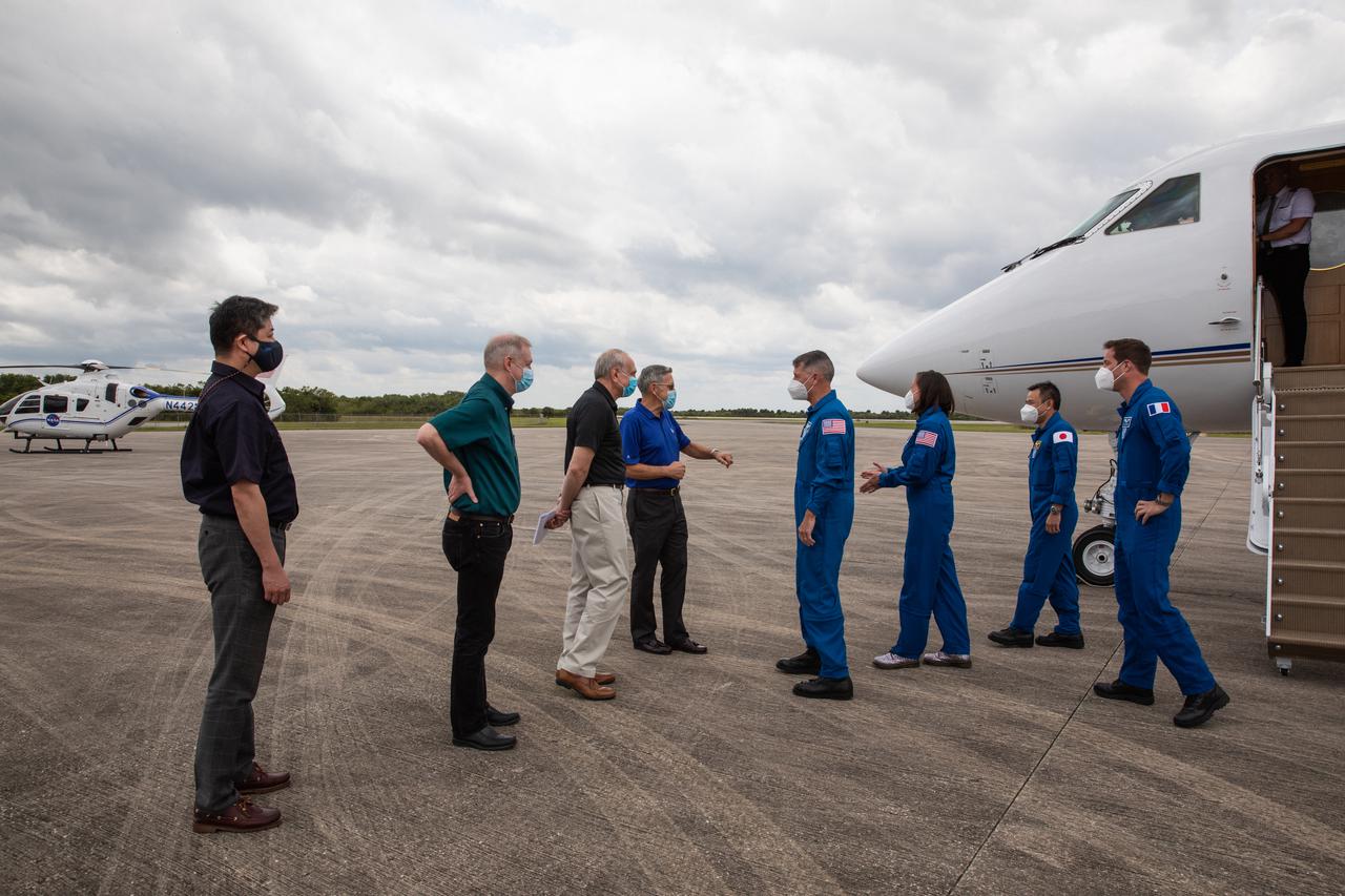 From left to right, Crew-2 mission astronauts Shane Kimbrough (NASA), Megan McArthur (NASA), Akihiko Hoshide (JAXA), and Thomas Pesquet (ESA), arrive at Kennedy Space Center’s Launch and Landing Facility on April 16, 2021. There to greet the astronauts, from left to right, are: Junichi Sakai, manager, International Space Station Program, JAXA; Frank de Winne, manager, International Space Station Program, ESA; Steve Jurczyk, acting administrator, NASA; and Bob Cabana, Director, Kennedy. The Crew-2 mission is set to lift off from Kennedy’s Launch Complex 39A on April 22, at 6:11 a.m. EDT.