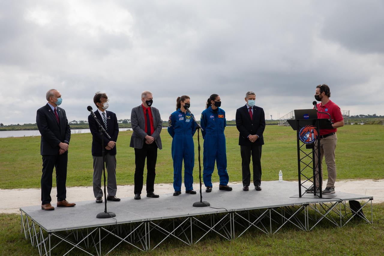 At right, moderator Joshua Santora, NASA Communications, addresses the participants in a NASA Social Facebook Live event held April 21, 2021, near the Press Site countdown clock at NASA’s Kennedy Space Center in Florida, ahead of the agency’s SpaceX Crew-2 launch. Participants, from left to right, are: Steve Jurczyk, acting NASA administrator; Hiroshi Sasaki, vice president and director general, JAXA’s Human Spaceflight Technology Directorate; Frank de Winne, manager, International Space Station Program, ESA; NASA astronauts Tracy Caldwell Dyson and Jasmin Moghbeli; and Kennedy Director Bob Cabana. Crew-2 is the second regular crew mission of a U.S. commercial spacecraft with astronauts to the International Space Station as part of NASA’s Commercial Crew Program. The SpaceX Crew Dragon Endeavour capsule will launch atop the company’s Falcon 9 rocket from Launch Complex 39A to the space station for a six-month science mission. Liftoff is targeted for Friday, April 23, at 5:49 a.m. EDT.