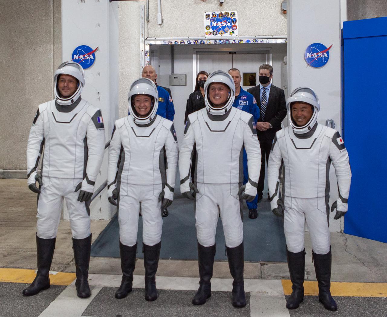 NASA SpaceX’s Crew-2 astronauts emerge from the Neil Armstrong Operations and Checkout Building at NASA’s Kennedy Space Center in Florida on April 23, 2021. From left are ESA astronaut Thomas Pesquet, mission specialist; NASA astronaut Megan McArthur, pilot; NASA astronaut Shane Kimbrough, spacecraft commander; and JAXA astronaut Akihiko Hoshide, mission specialist. They will board two Tesla vehicles for the trip to Kennedy’s Launch Complex 39A. Crew-2 is the second regular crew mission of a U.S. commercial spacecraft with astronauts to the International Space Station as part of NASA’s Commercial Crew Program. The SpaceX Crew Dragon Endeavour will launch atop the company’s Falcon 9 rocket from Pad 39A to the space station for a six-month science mission.
