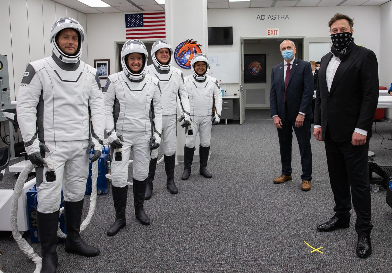 SpaceX CEO and founder Elon Musk and NASA acting administrator Steve Jurczyk visit with from left, ESA astronaut Thomas Pesquet, NASA astronaut Megan McArthur, NASA astronaut Shane Kimbrough and JAXA astronaut Akihiko Hoshide inside the crew suit-up room in the Neil Armstrong Operations and Checkout Building at NASA’s Kennedy Space Center in Florida, on April 23, 2021. The four astronauts will head to the International Space Station on NASA’s SpaceX Crew-2 mission. SpaceX’s Crew Dragon Endeavour will launch on the company’s Falcon 9 rocket from Kennedy’s Launch Complex 39A today at 5:49 a.m. EDT.