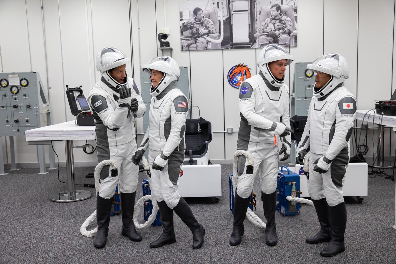 From left, ESA astronaut Thomas Pesquet, NASA astronaut Megan McArthur, NASA astronaut Shane Kimbrough and JAXA astronaut Akihiko Hoshide get ready inside the crew suit-up room in the Neil Armstrong Operations and Checkout Building at NASA’s Kennedy Space Center in Florida, on April 23, 2021. The four astronauts will head to the International Space Station on NASA’s SpaceX Crew-2 mission. SpaceX’s Crew Dragon Endeavour will launch on the company’s Falcon 9 rocket from Kennedy’s Launch Complex 39A today at 5:49 a.m. EDT.