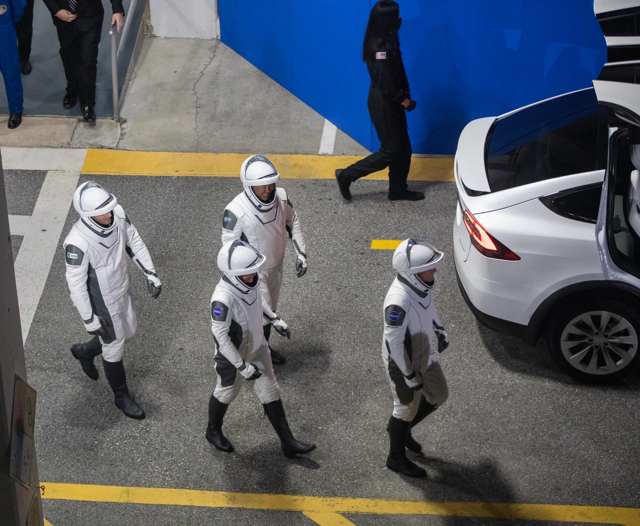 NASA SpaceX’s Crew-2 astronauts walk outside of the Neil Armstrong Operations and Checkout Building at NASA’s Kennedy Space Center in Florida on April 23, 2021. NASA astronaut Shane Kimbrough, spacecraft commander; NASA astronaut Megan McArthur, pilot; ESA astronaut Thomas Pesquet, mission specialist; and JAXA astronaut Akihiko Hoshide, mission specialist then boarded two Tesla vehicles for the trip to Kennedy’s Launch Complex 39A. Crew-2 is the second regular crew mission of a U.S. commercial spacecraft with astronauts to the International Space Station as part of NASA’s Commercial Crew Program. The SpaceX Crew Dragon Endeavour will launch atop the company’s Falcon 9 rocket from Pad 39A to the space station for a six-month science mission.