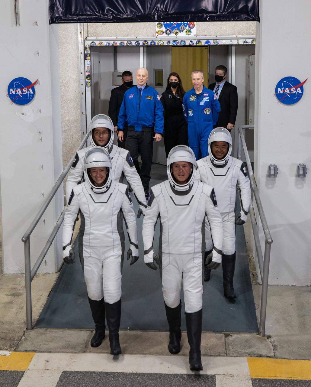 NASA SpaceX’s Crew-2 astronauts emerge from the Neil Armstrong Operations and Checkout Building at NASA’s Kennedy Space Center in Florida on April 23, 2021. In front, from left, are NASA astronaut Megan McArthur, pilot, and NASA astronaut Shane Kimbrough, spacecraft commander. Behind them, from left, are ESA astronaut Thomas Pesquet, mission specialist, and JAXA astronaut Akihiko Hoshide, mission specialist. They will board two Tesla vehicles for the trip to Kennedy’s Launch Complex 39A. Crew-2 is the second regular crew mission of a U.S. commercial spacecraft with astronauts to the International Space Station as part of NASA’s Commercial Crew Program. The SpaceX Crew Dragon Endeavour will launch atop the company’s Falcon 9 rocket from Pad 39A to the space station for a six-month science mission.