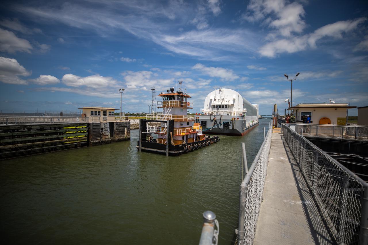 After its journey from NASA’s Stennis Space Center in Mississippi aboard the Pegasus barge, the mighty Space Launch System (SLS) core stage passes through Port Canaveral on its way to the agency’s Kennedy Space Center in Florida on April 27, 2021. The core stage is the final piece of Artemis hardware to arrive at the spaceport and will be offloaded and moved to Kennedy’s Vehicle Assembly Building, where it will be prepared for integration atop the mobile launcher with the completed stack of solid rocket boosters ahead of the Artemis I launch. The first in a series of increasingly complex missions, Artemis I will test SLS and Orion as an integrated system prior to crewed flights to the Moon.