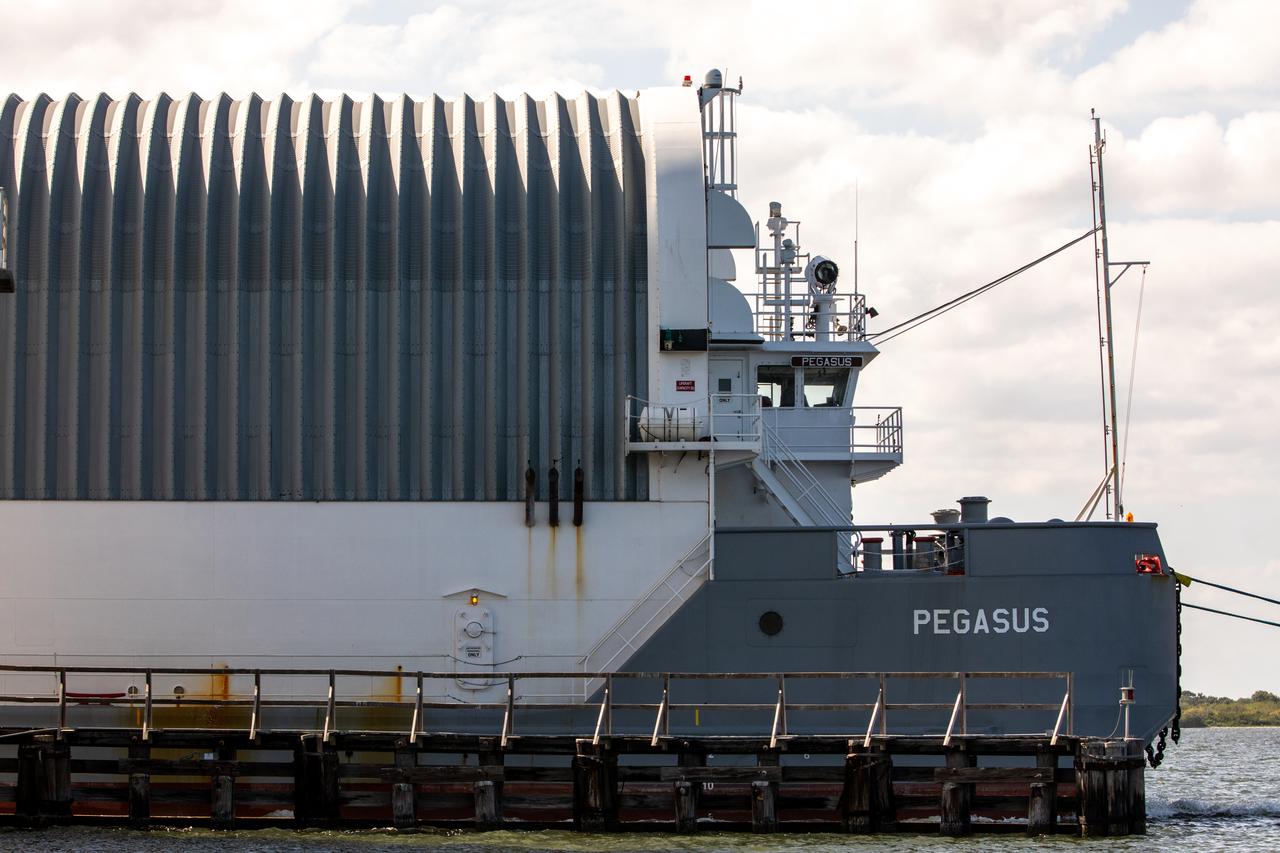 The Pegasus barge, carrying the mighty Space Launch System (SLS) core stage, arrives at NASA’s Kennedy Space Center in Florida on April 27, 2021, after journeying from the agency’s Stennis Space Center in Mississippi. The core stage is the final piece of Artemis hardware to arrive at the spaceport and will be offloaded and moved to Kennedy’s Vehicle Assembly Building, where it will be prepared for integration atop the mobile launcher with the completed stack of solid rocket boosters ahead of the Artemis I launch. The first in a series of increasingly complex missions, Artemis I will test SLS and Orion as an integrated system prior to crewed flights to the Moon.