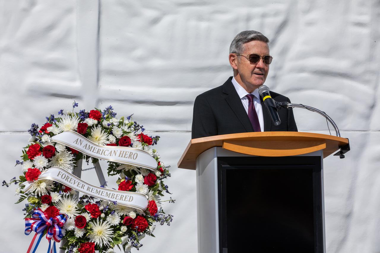 Kennedy Space Center Director Bob Cabana provides remarks during a wreath-laying ceremony in Florida, honoring the memory of former Apollo 11 astronaut Michael Collins on April 30, 2021. Therrin Protze, chief operating officer of Delaware North at Kennedy’s visitor complex, also spoke during the ceremony, held just outside of the Heroes and Legends exhibit at the visitor complex. Collins served as pilot on the three-day Gemini X mission in 1966, and he was the command module pilot for the historic Apollo 11 mission in 1969, where he remained in lunar orbit while Neil Armstrong and Buzz Aldrin become the first people to walk on the Moon. Collins passed away on April 28, 2021, at the age of 90.
