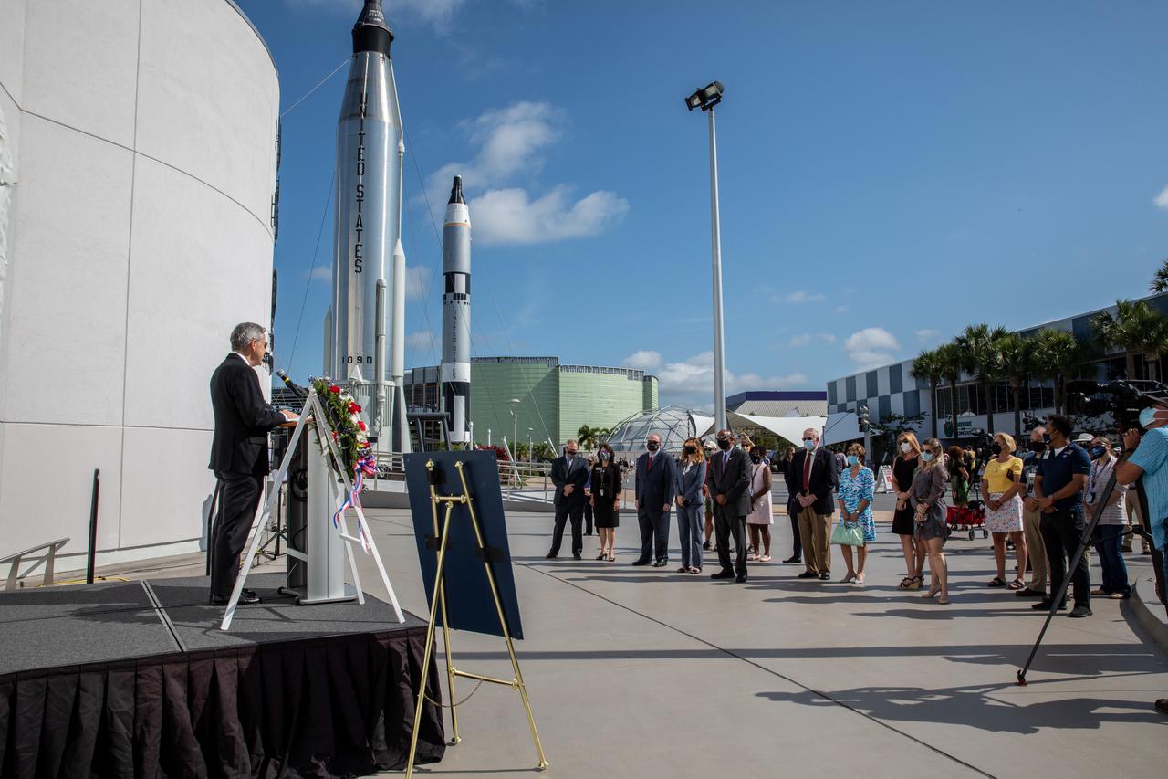 Kennedy Space Center Director Bob Cabana provides remarks during a wreath-laying ceremony in Florida, honoring the memory of former Apollo 11 astronaut Michael Collins on April 30, 2021. Therrin Protze, chief operating officer of Delaware North at Kennedy’s visitor complex, also spoke during the ceremony, held just outside of the Heroes and Legends exhibit at the visitor complex. Collins served as pilot on the three-day Gemini X mission in 1966, and he was the command module pilot for the historic Apollo 11 mission in 1969, where he remained in lunar orbit while Neil Armstrong and Buzz Aldrin become the first people to walk on the Moon. Collins passed away on April 28, 2021, at the age of 90.