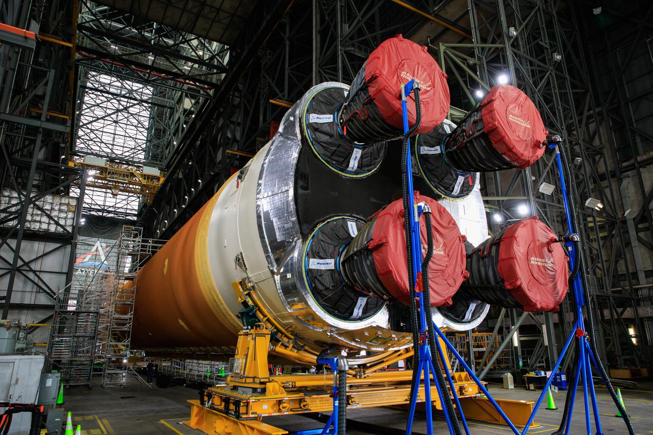 The Space Launch System (SLS) core stage for NASA’s Artemis I mission is in the transfer aisle of the Vehicle Assembly Building at Kennedy Space Center in Florida on May 5, 2021. Teams from the center’s Exploration Ground Systems and contractor Jacobs will perform checkouts ahead of integrating the massive rocket stage with the twin solid rocket boosters, Orion spacecraft, and additional flight hardware ahead of the Artemis I launch. Artemis I will be the first integrated test of SLS and Orion and will pave the way for landing the first woman and first person of color on the lunar surface. It will be a proving ground for deep space exploration, leading the agency’s efforts under the Artemis program for a sustainable presence on the Moon and preparing for human missions to Mars. 