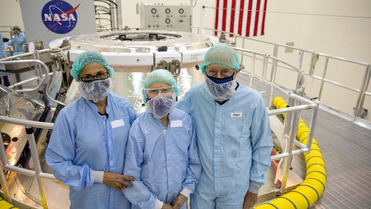 From left to right, Nicole Stott, NASA Astronaut (former); Dottie Duke, wife of Charlie Duke; and Charlie Duke, NASA Astronaut (former), shown in front of the Orion spacecraft for the Artemis I mission, inside the Multi-Payload Processing Facility (MPPF) during a visit to NASA’s Kennedy Space Center in Florida on May 10, 2021. The first in a series of increasingly complex missions, Artemis I will test Orion and the Space Launch System rocket as an integrated system prior to crewed flights to the Moon. 