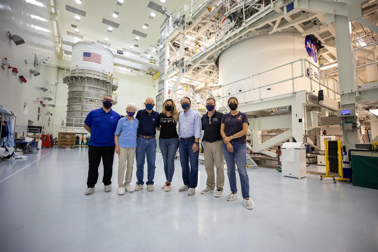 From left to right, Adam Leppek, ARES Corporation (KLXSIII), Deputy Element Operations Manager; Dottie Duke, wife of Charlie Duke; Charlie Duke, NASA Astronaut (former); Christina Korp, Assistant to Charlie Duke; Jim Keys, Pilot; Nick Kindred, Jacobs Technology, Flow Manager; and Nicole Stott, NASA Astronaut (former), shown in the Multi-Payload Processing Facility (MPPF) at NASA's Kennedy Space Center in Florida on May 10, 2021. In the background, on the left, is the Interim Cryogenic Propulsion Stage for the Space Launch System (SLS) rocket. On the right, the NASA “meatball” insignia and ESA (European Space Agency) logos on the European-built service module are visible. Both pieces of hardware will undergo fueling and servicing in the facility ahead of the Artemis I launch by teams from NASA’s Exploration Ground Systems and their primary contractor, Jacobs Technology. The first in a series of increasingly complex missions, Artemis I will test Orion and the Space Launch System rocket as an integrated system prior to crewed flights to the Moon.