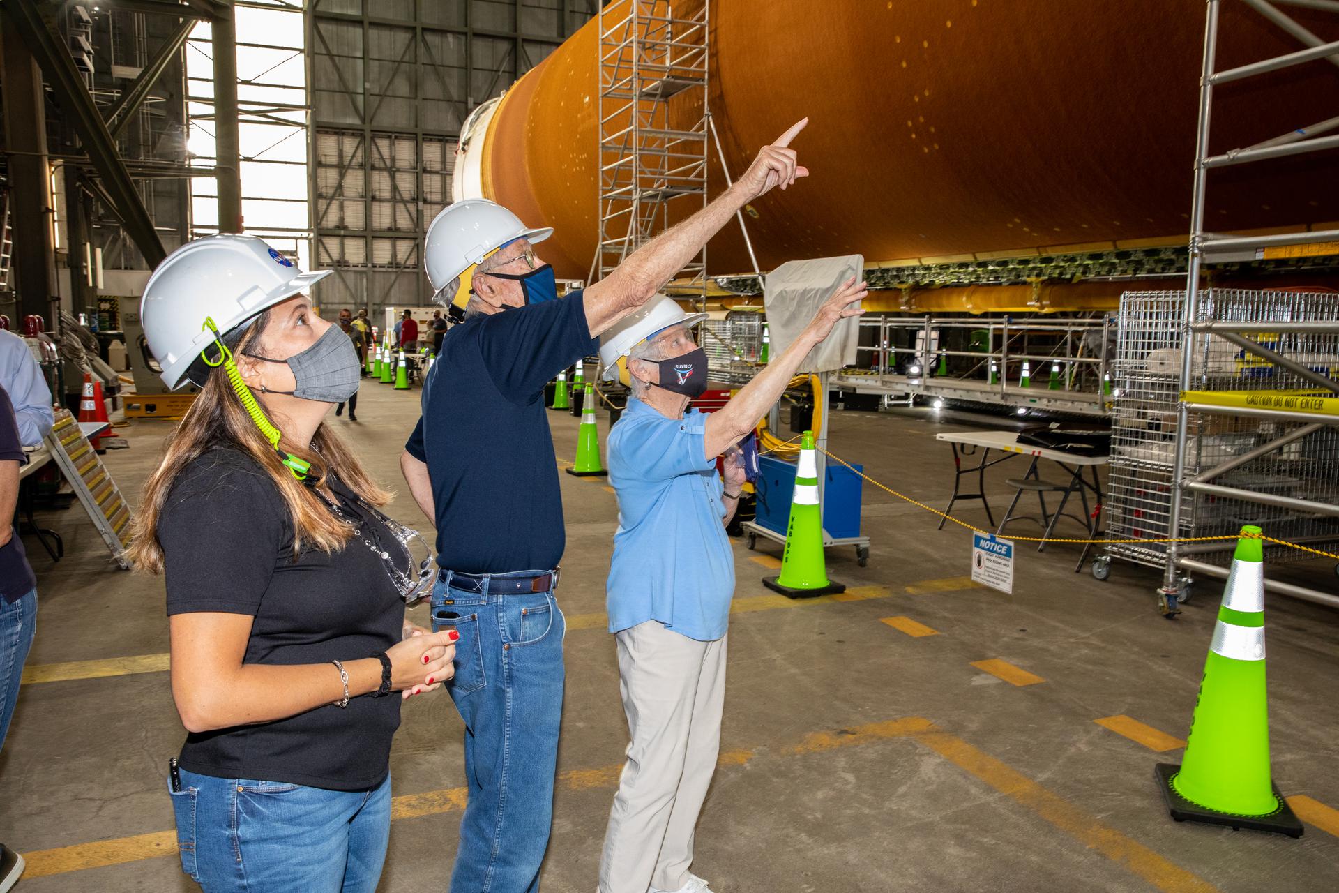 Charlie Duke and his wife view the SLS core stage at KSC