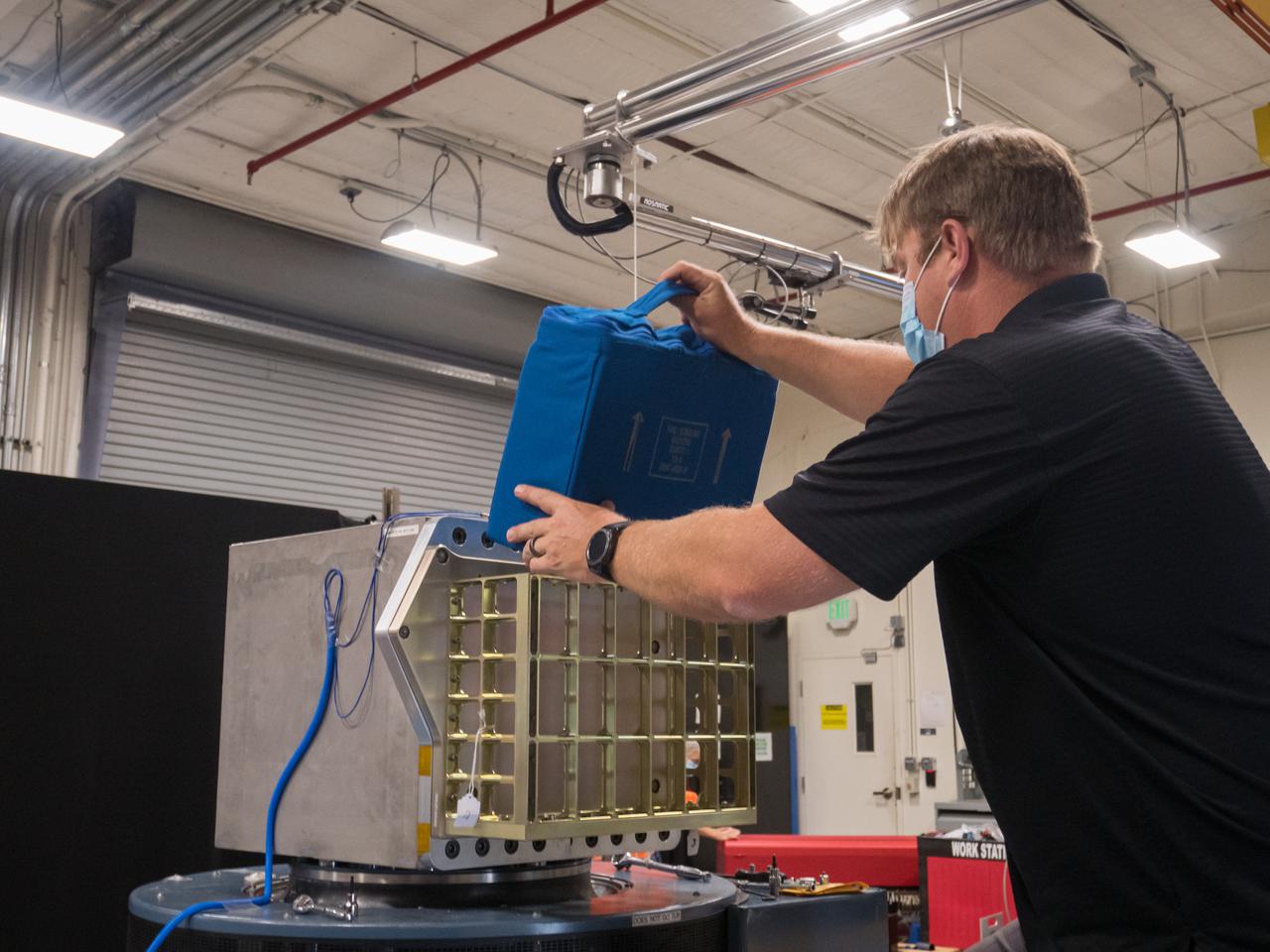 Adam Chaney, a mechanical engineer with the Laboratory Support Services and Operations (LASSO) contract at NASA’s Kennedy Space Center in Florida, prepares NASA’s Biology Experiment-1 (BioExpt-1) for testing in the Vibration Laboratory at Kennedy Space Center in Florida on May 13, 2021. BioExpt-1 is a space biology pathfinder, which will carry plants, algae, yeast, and fungi for biology research beyond low-Earth orbit (LEO). NASA will install the BioExpt-1 payload container assembles onto panels inside the Orion capsule. BioExpt-1 will return these science payloads to Earth to provide critical and unique data about life beyond LEO for the first time in more than 40 years. Artemis I is the first in a series of increasingly complex missions that will enable human exploration of the Moon and eventually on to Mars.