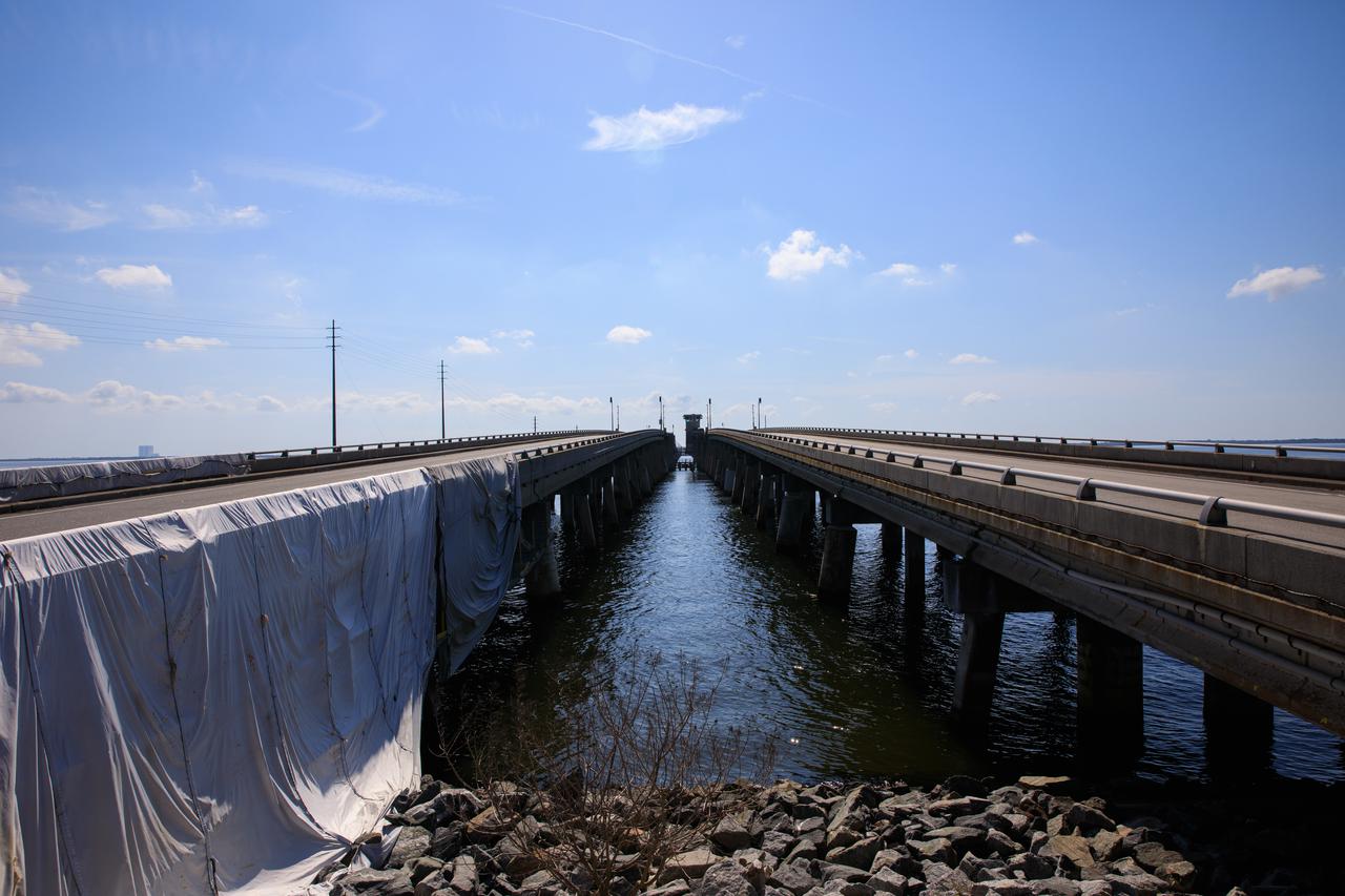 NASA’s bridge engineering team at Kennedy Space Center is managing multiple critical projects on the Indian River Bridge. This includes running new utility lines and safeguarding the existing wires and piping prior to the beginning of construction of the new Brevard County bridge. The much-traveled structure is a key access and evacuation route for the Florida spaceport and Cape Canaveral Space Force Station. Also known as the NASA Causeway Bridge, the Indian River Bridge was built in 1964.