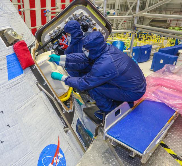 Technicians place cargo inside Boeing’s CST-100 Starliner ahead of Orbital Flight Test-2 (OFT-2) in the Commercial Crew and Cargo Processing Facility at NASA’s Kennedy Space Center in Florida on May 28, 2021. Part of the agency’s Commercial Crew Program, OFT-2 is a critical developmental milestone on the company’s path to fly crew missions for NASA.