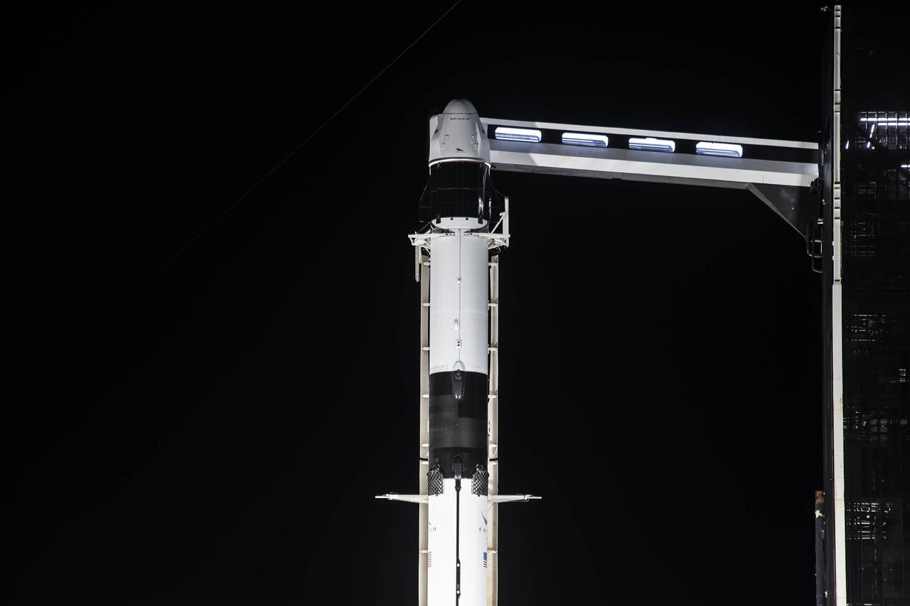 A close-up view of the SpaceX Falcon 9 rocket with the Dragon capsule atop in the vertical position on June 2, 2021, at Launch Complex 39A at NASA’s Kennedy Space Center in Florida, in preparation for the company’s 22nd Commercial Resupply Services mission for NASA to the International Space Station. In view is the access arm. Dragon will deliver more than 7,300 pounds of cargo to the space station. Liftoff is scheduled for 1:29 p.m. EDT on Thursday, June 3.
