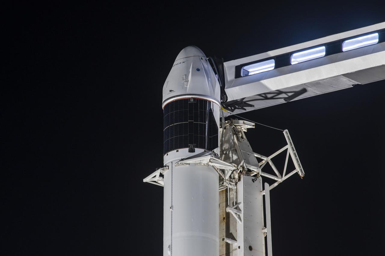 A close-up view of the SpaceX Falcon 9 rocket with the Dragon capsule atop in the vertical position on June 2, 2021, at Launch Complex 39A at NASA’s Kennedy Space Center in Florida, in preparation for the company’s 22nd Commercial Resupply Services mission for NASA to the International Space Station. In view is the access arm. Dragon will deliver more than 7,300 pounds of cargo to the space station. Liftoff is scheduled for 1:29 p.m. EDT on Thursday, June 3. 