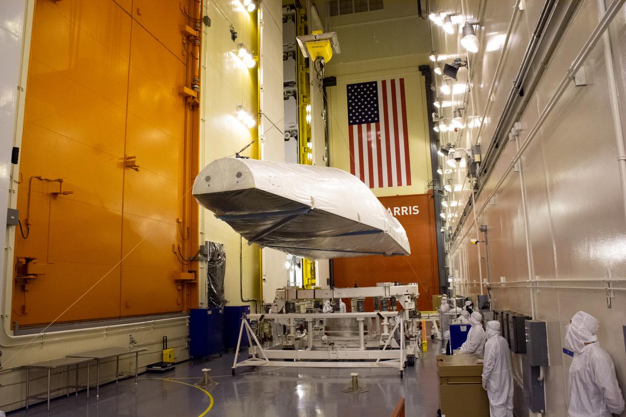 Inside the Integrated Processing Facility at Vandenberg Space Force Base in California, the first of two payload fairings for the United Launch Alliance Atlas V rocket is lifted by crane on June 3, 2021, to prepare it for NASA’s Landsat 9 satellite. The Atlas V will launch NASA’s Landsat 9 satellite from Vandenberg in September 2021. The launch is being managed by NASA’s Launch Services Program based at Kennedy Space Center. Landsat 9 will continue the nearly 50-year legacy of previous Landsat missions. It will monitor key natural and economic resources from orbit. Landsat 9 is managed by the agency’s Goddard Space Flight Center in Greenbelt, Maryland. It will carry two instruments: the Operational Land Imager 2, which collects images of Earth’s landscapes in visible, near infrared and shortwave infrared light, and the Thermal Infrared Sensor 2, which measures the temperature of land surfaces. Like its predecessors, Landsat 9 is a joint mission between NASA and the U.S. Geological Survey.