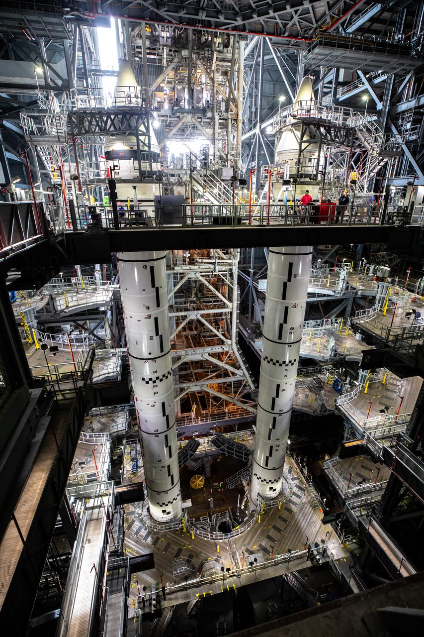 The fully stacked twin solid rocket boosters for NASA’s Space Launch System (SLS) rocket are seen on top of the mobile launcher inside High Bay 3 of the Vehicle Assembly Building (VAB) at the agency’s Kennedy Space Center in Florida on June 4, 2021. Now that booster stacking is complete, teams with NASA’s Exploration Ground Systems and contractor Jacobs are preparing to integrate the massive core stage, which arrived at Kennedy in April 2020, with the boosters inside the VAB. The 188,000-pound core stage alone will provide more than 2 million pounds of thrust at launch, and coupled with the boosters, will provide more than 8.8 million pounds of thrust to launch the Artemis I mission. The first in an increasingly complex series of missions, Artemis I will test SLS and the Orion spacecraft as an integrated system ahead of crewed flights to the Moon.