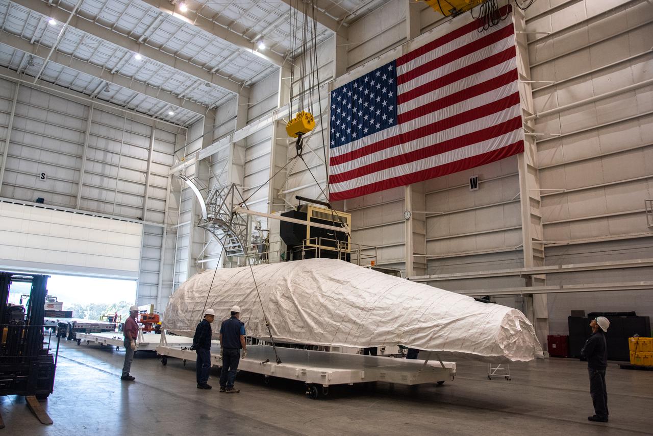 The second of two payload fairings for the United Launch Alliance Atlas V rocket arrives inside the Integrated Processing Facility at Vandenberg Space Force Base in California, on June 4, 2021, to prepare it for NASA’s Landsat 9 satellite. The Landsat 9 satellite will launch atop the Atlas V from Vandenberg in September 2021. The launch is being managed by NASA’s Launch Services Program based at Kennedy Space Center. Landsat 9 will continue the nearly 50-year legacy of previous Landsat missions. It will monitor key natural and economic resources from orbit. Landsat 9 is managed by the agency’s Goddard Space Flight Center in Greenbelt, Maryland. It will carry two instruments: the Operational Land Imager 2, which collects images of Earth’s landscapes in visible, near infrared and shortwave infrared light, and the Thermal Infrared Sensor 2, which measures the temperature of land surfaces. Like its predecessors, Landsat 9 is a joint mission between NASA and the U.S. Geological Survey.