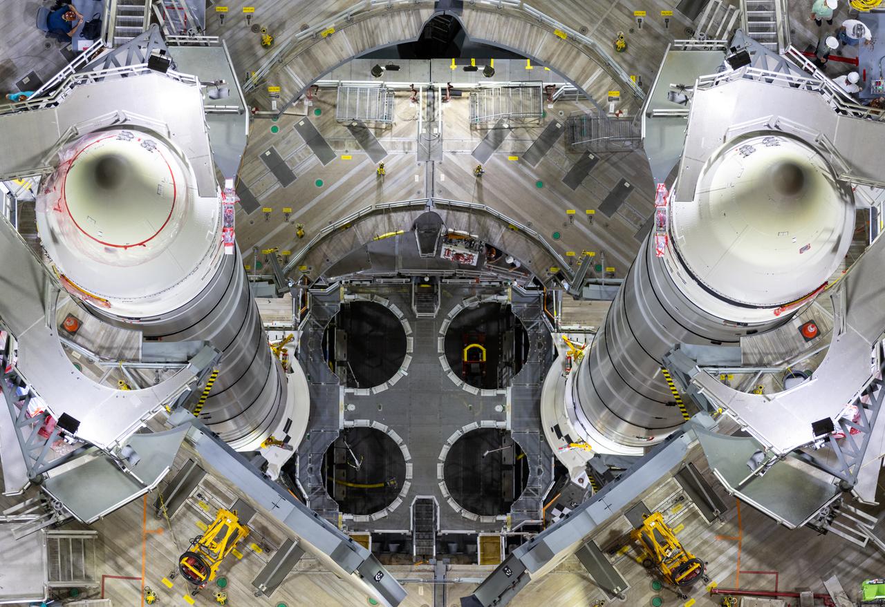 An overhead view shows the fully stacked twin solid rocket boosters for NASA’s Space Launch System (SLS) rocket on top of the mobile launcher inside High Bay 3 of the Vehicle Assembly Building (VAB) at the agency’s Kennedy Space Center in Florida on June 9, 2021. Teams with NASA’s Exploration Ground Systems and contractor Jacobs are making final preparations to integrate the boosters with the SLS core stage, which arrived at Kennedy in April 2020. Manufactured by Northrop Grumman in Utah, the twin boosters provide more than 75 percent of the total SLS thrust at launch. When integrated, the 212-foot, 188,000-pound core stage and twin boosters will provide more than 8.8 million pounds of thrust to launch Artemis I. The first in an increasingly complex series of missions, Artemis I will test SLS and the Orion spacecraft as an integrated system ahead of crewed flights in which NASA will land the first woman and person of color on the Moon.