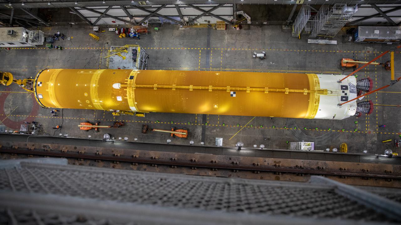 In this aerial view, teams with NASA’s Exploration Ground Systems and contractor Jacobs lift the Space Launch System (SLS) core stage – the largest part of the rocket – and prepare to move it over to High Bay 3 in the Vehicle Assembly Building, where it will be placed atop the mobile launcher in between the twin solid rocket boosters, at NASA’s Kennedy Space Center in Florida on June 10, 2021. The 188,000-pound core stage, with its four RS-25 engines, will provide more than 2 million pounds of thrust during launch and ascent, and coupled with the boosters, will provide more than 8.8 million pounds of thrust to send the Artemis I mission to space. Under the Artemis program, NASA will land the first woman and first person of color on the Moon, as well as establish a sustainable presence on the lunar surface in preparation for human missions to Mars.
