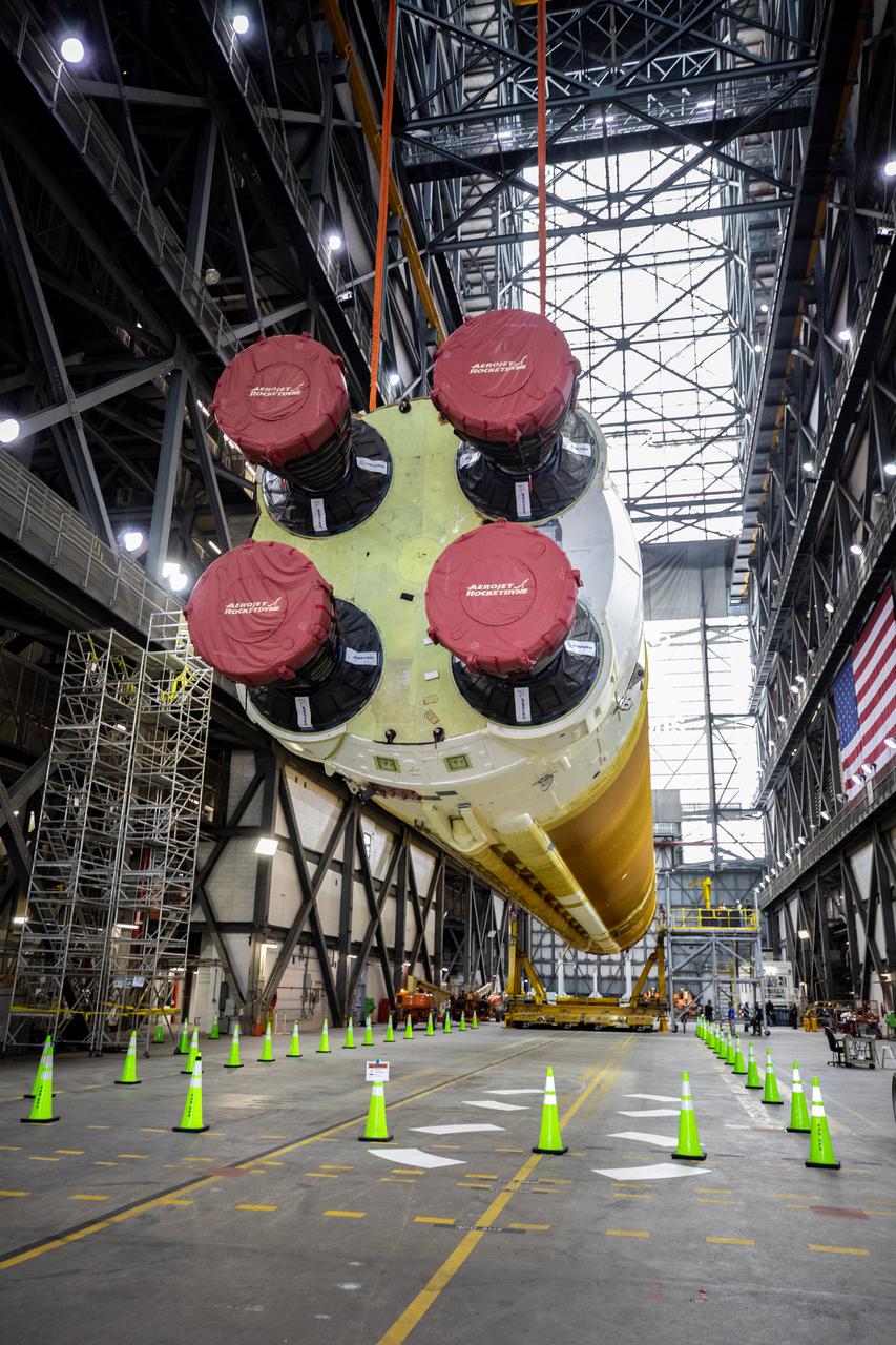 Teams with NASA’s Exploration Ground Systems and contractor Jacobs lift the Space Launch System (SLS) core stage – the largest part of the rocket – and prepare to move it over to High Bay 3 in the Vehicle Assembly Building, where it will be placed atop the mobile launcher in between the twin solid rocket boosters, at NASA’s Kennedy Space Center in Florida on June 10, 2021. The 188,000-pound core stage, with its four RS-25 engines, will provide more than 2 million pounds of thrust during launch and ascent, and coupled with the boosters, will provide more than 8.8 million pounds of thrust to send the Artemis I mission to space. Under the Artemis program, NASA will land the first woman and first person of color on the Moon, as well as establish a sustainable presence on the lunar surface in preparation for human missions to Mars.