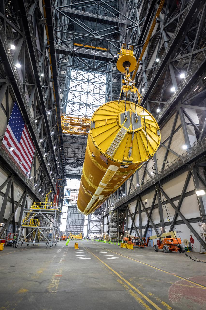 Teams with NASA’s Exploration Ground Systems and contractor Jacobs lift the Space Launch System (SLS) core stage – the largest part of the rocket – and prepare to move it over to High Bay 3 in the Vehicle Assembly Building, where it will be placed atop the mobile launcher in between the twin solid rocket boosters, at NASA’s Kennedy Space Center in Florida on June 10, 2021. The 188,000-pound core stage, with its four RS-25 engines, will provide more than 2 million pounds of thrust during launch and ascent, and coupled with the boosters, will provide more than 8.8 million pounds of thrust to send the Artemis I mission to space. Under the Artemis program, NASA will land the first woman and first person of color on the Moon, as well as establish a sustainable presence on the lunar surface in preparation for human missions to Mars.