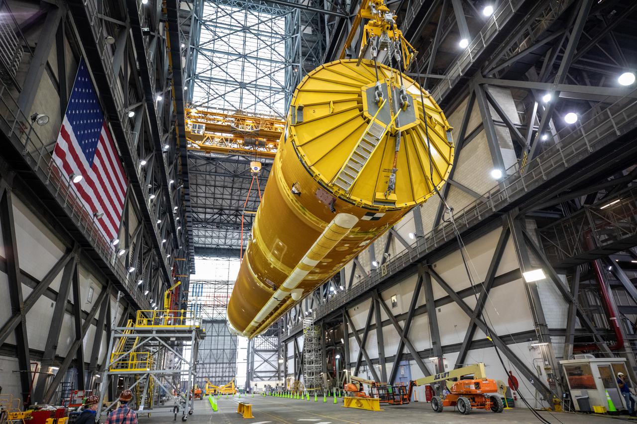 Teams with NASA’s Exploration Ground Systems and contractor Jacobs lift the Space Launch System (SLS) core stage – the largest part of the rocket – and prepare to move it over to High Bay 3 in the Vehicle Assembly Building, where it will be placed atop the mobile launcher in between the twin solid rocket boosters, at NASA’s Kennedy Space Center in Florida on June 10, 2021. The 188,000-pound core stage, with its four RS-25 engines, will provide more than 2 million pounds of thrust during launch and ascent, and coupled with the boosters, will provide more than 8.8 million pounds of thrust to send the Artemis I mission to space. Under the Artemis program, NASA will land the first woman and first person of color on the Moon, as well as establish a sustainable presence on the lunar surface in preparation for human missions to Mars.