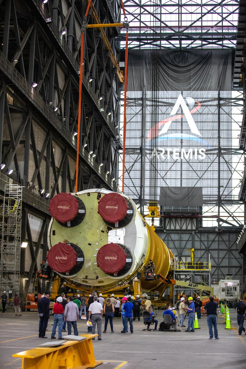 The Space Launch System (SLS) core stage is seen in the transfer aisle of the Vehicle Assembly Building (VAB) at NASA’s Kennedy Space Center in Florida on June 10, 2021. Teams with the agency’s Exploration Ground Systems and contractor Jacobs are preparing to lift the 188,000-pound core stage and place it on the mobile launcher in between the two solid rocket boosters in High Bay 3 of the VAB. The core stage alone will provide more than 2 million pounds of thrust at launch, and coupled with the boosters, will provide more than 8.8 million pounds of thrust to launch the Artemis I mission. The first in an increasingly complex series of missions, Artemis I will test SLS and the Orion spacecraft as an integrated system ahead of crewed flights to the Moon.