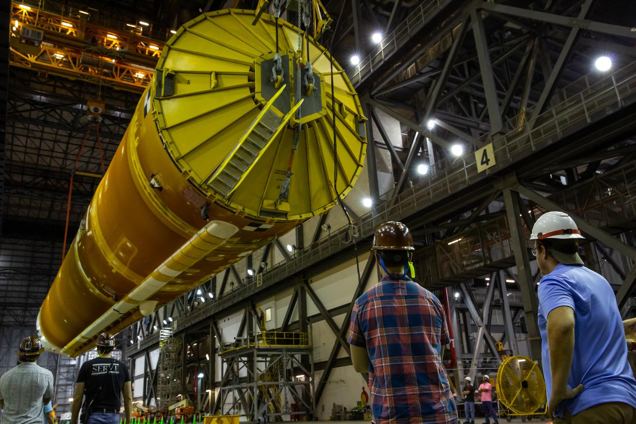Teams with NASA’s Exploration Ground Systems and contractor Jacobs lift the Space Launch System (SLS) core stage – the largest part of the rocket – and prepare to move it over to High Bay 3 in the Vehicle Assembly Building, where it will be placed atop the mobile launcher in between the twin solid rocket boosters, at NASA’s Kennedy Space Center in Florida on June 11, 2021. The 188,000-pound core stage, with its four RS-25 engines, will provide more than 2 million pounds of thrust during launch and ascent, and coupled with the boosters, will provide more than 8.8 million pounds of thrust to send the Artemis I mission to space. Under the Artemis program, NASA will land the first woman and first person of color on the Moon, as well as establish a sustainable presence on the lunar surface in preparation for human missions to Mars.