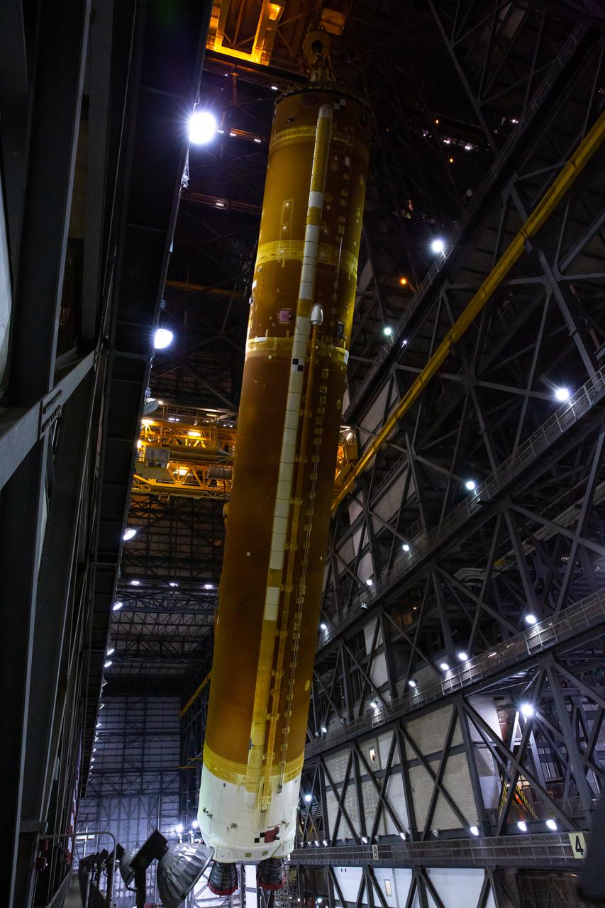 Teams with NASA’s Exploration Ground Systems and contractor Jacobs rotate the Space Launch System (SLS) core stage – the largest part of the rocket – into a vertical position in preparation for its move to High Bay 3 in the Vehicle Assembly Building, where it will be placed atop the mobile launcher in between the twin solid rocket boosters, at NASA’s Kennedy Space Center in Florida on June 11, 2021. The 188,000-pound core stage, with its four RS-25 engines, will provide more than 2 million pounds of thrust during launch and ascent, and coupled with the boosters, will provide more than 8.8 million pounds of thrust to send the Artemis I mission to space. Under the Artemis program, NASA will land the first woman and first person of color on the Moon, as well as establish a sustainable presence on the lunar surface in preparation for human missions to Mars.