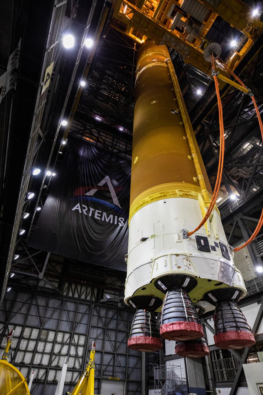 Teams with NASA’s Exploration Ground Systems and contractor Jacobs rotate the Space Launch System (SLS) core stage – the largest part of the rocket – into a vertical position in preparation for its move to High Bay 3 in the Vehicle Assembly Building, where it will be placed atop the mobile launcher in between the twin solid rocket boosters, at NASA’s Kennedy Space Center in Florida on June 11, 2021. The 188,000-pound core stage, with its four RS-25 engines, will provide more than 2 million pounds of thrust during launch and ascent, and coupled with the boosters, will provide more than 8.8 million pounds of thrust to send the Artemis I mission to space. Under the Artemis program, NASA will land the first woman and first person of color on the Moon, as well as establish a sustainable presence on the lunar surface in preparation for human missions to Mars.