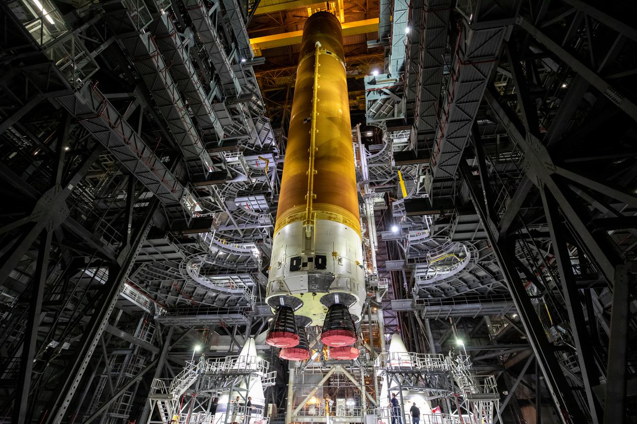 Teams with NASA’s Exploration Ground Systems and contractor Jacobs prepare to lower the Space Launch System (SLS) core stage – the largest part of the rocket – onto the mobile launcher, in between the twin solid rocket boosters, inside High Bay 3 of the Vehicle Assembly Building at NASA’s Kennedy Space Center in Florida on June 12, 2021. The 188,000-pound core stage, with its four RS-25 engines, will provide more than 2 million pounds of thrust during launch and ascent, and coupled with the boosters, will provide more than 8.8 million pounds of thrust to send the Artemis I mission to space. Under the Artemis program, NASA will land the first woman and first person of color on the Moon, as well as establish a sustainable presence on the lunar surface in preparation for human missions to Mars.