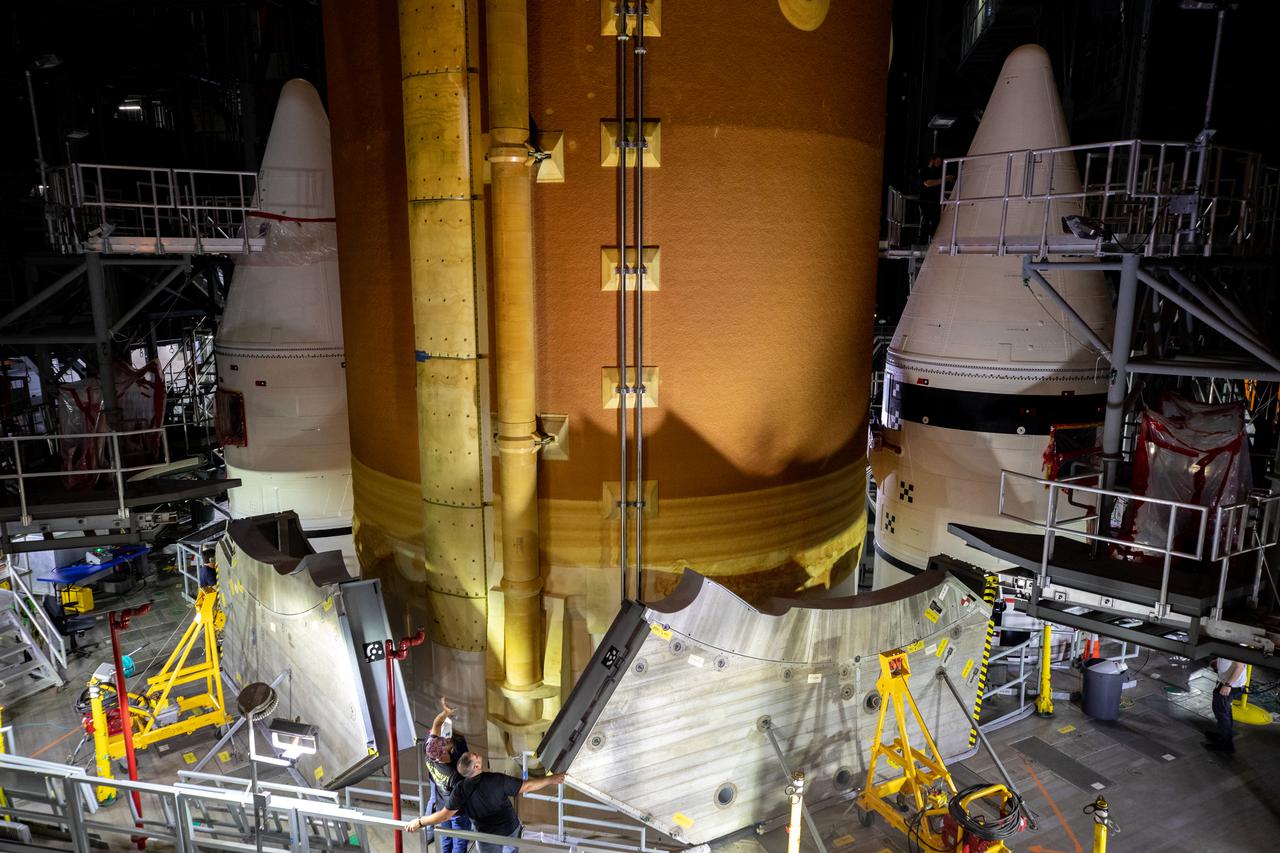 Teams with NASA’s Exploration Ground Systems and contractor Jacobs lower the Space Launch System (SLS) core stage – the largest part of the rocket – onto the mobile launcher, in between the twin solid rocket boosters, inside High Bay 3 of the Vehicle Assembly Building at NASA’s Kennedy Space Center in Florida on June 12, 2021. The 188,000-pound core stage, with its four RS-25 engines, will provide more than 2 million pounds of thrust during launch and ascent, and coupled with the boosters, will provide more than 8.8 million pounds of thrust to send the Artemis I mission to space. Under the Artemis program, NASA will land the first woman and first person of color on the Moon, as well as establish a sustainable presence on the lunar surface in preparation for human missions to Mars. 