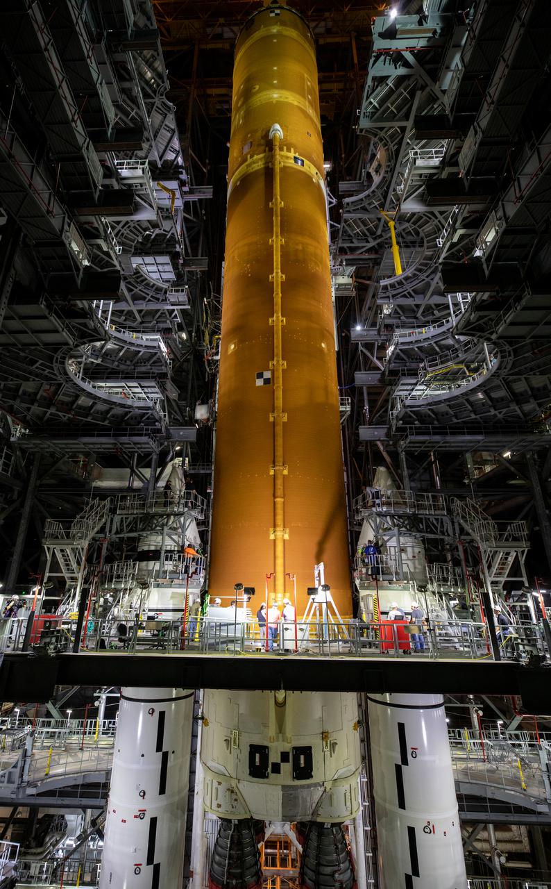 Teams with NASA’s Exploration Ground Systems and contractor Jacobs lower the Space Launch System (SLS) core stage – the largest part of the rocket – onto the mobile launcher, in between the twin solid rocket boosters, inside High Bay 3 of the Vehicle Assembly Building at NASA’s Kennedy Space Center in Florida on June 12, 2021. The 188,000-pound core stage, with its four RS-25 engines, will provide more than 2 million pounds of thrust during launch and ascent, and coupled with the boosters, will provide more than 8.8 million pounds of thrust to send the Artemis I mission to space. Under the Artemis program, NASA will land the first woman and first person of color on the Moon, as well as establish a sustainable presence on the lunar surface in preparation for human missions to Mars.