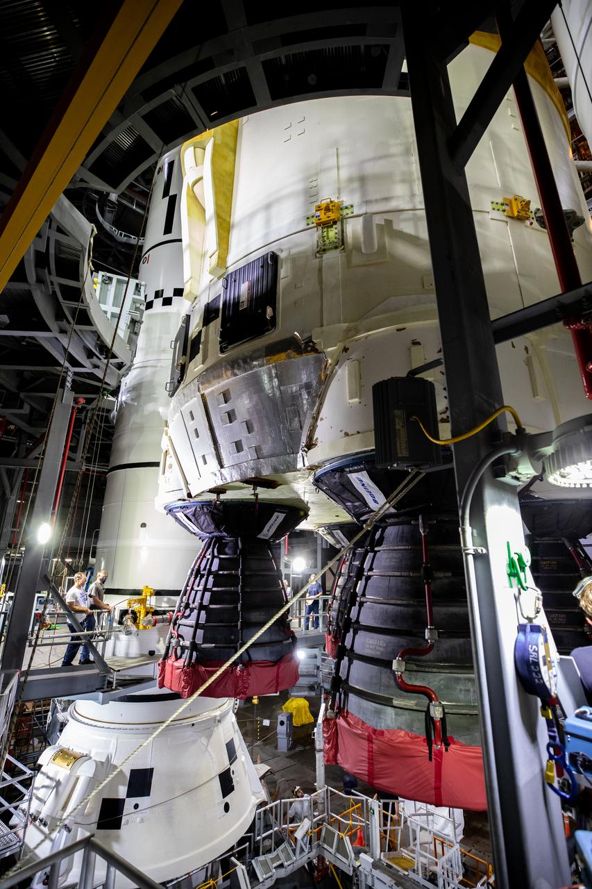 Teams with NASA’s Exploration Ground Systems and contractor Jacobs lower the Space Launch System (SLS) core stage – the largest part of the rocket – onto the mobile launcher, in between the twin solid rocket boosters, inside High Bay 3 of the Vehicle Assembly Building at NASA’s Kennedy Space Center in Florida on June 12, 2021. The 188,000-pound core stage, with its four RS-25 engines, will provide more than 2 million pounds of thrust during launch and ascent, and coupled with the boosters, will provide more than 8.8 million pounds of thrust to send the Artemis I mission to space. Under the Artemis program, NASA will land the first woman and first person of color on the Moon, as well as establish a sustainable presence on the lunar surface in preparation for human missions to Mars.