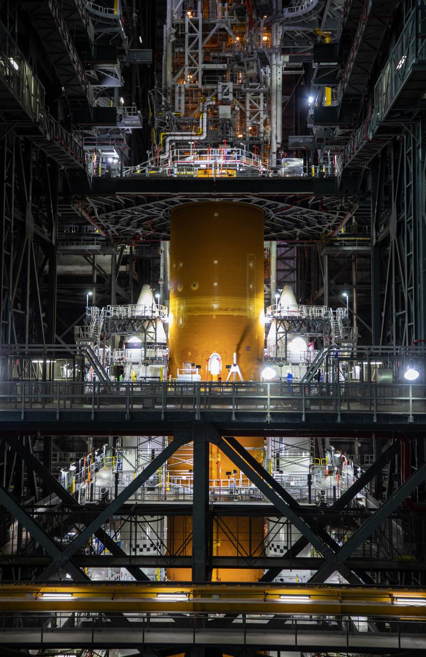 The Space Launch System (SLS) core stage is seen atop the mobile launcher inside High Bay 3 of the Vehicle Assembly Building at NASA’s Kennedy Space Center in Florida on June 15, 2021. Teams with NASA’s Exploration Ground Systems and contractor Jacobs lifted and lowered the core stage – the largest part of the rocket – onto the mobile launcher, placing it in between the twin solid rocket boosters. The 188,000-pound core stage, with its four RS-25 engines, will provide more than 2 million pounds of thrust during launch and ascent, and coupled with the boosters, will provide more than 8.8 million pounds of thrust to send the Artemis I mission to space. Under the Artemis program, NASA will land the first woman and first person of color on the Moon, as well as establish a sustainable presence on the lunar surface in preparation for human missions to Mars.