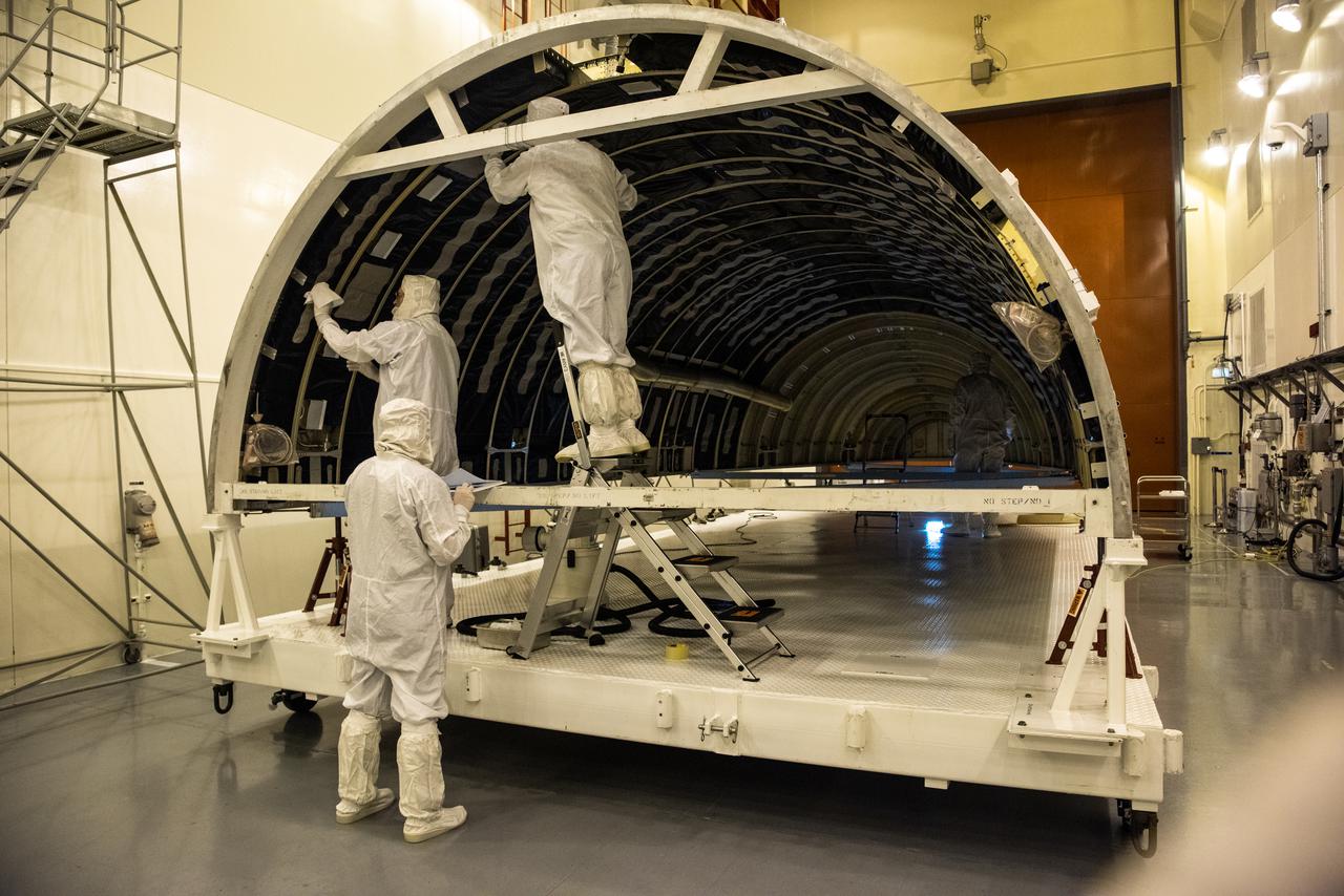 Inside the Integrated Processing Facility at Vandenberg Space Force Base in California, United Launch Alliance (ULA) technicians prepare to perform ultraviolet and white light inspections on one of two ULA Atlas V rocket payload fairings for NASA’s Landsat 9 satellite on June 17, 2021. The fairings will encapsulate the satellite for its launch atop the Atlas V from Vandenberg in September 2021. The launch is being managed by NASA’s Launch Services Program based at Kennedy Space Center in Florida. Landsat 9 will continue the nearly 50-year legacy of previous Landsat missions. It will monitor key natural and economic resources from orbit. Landsat 9 is managed by the agency’s Goddard Space Flight Center in Greenbelt, Maryland. It will carry two instruments: the Operational Land Imager 2, which collects images of Earth’s landscapes in visible, near-infrared and shortwave infrared light, and the Thermal Infrared Sensor 2, which measures the temperature of land surfaces. Like its predecessors, Landsat 9 is a joint mission between NASA and the U.S. Geological Survey. 
