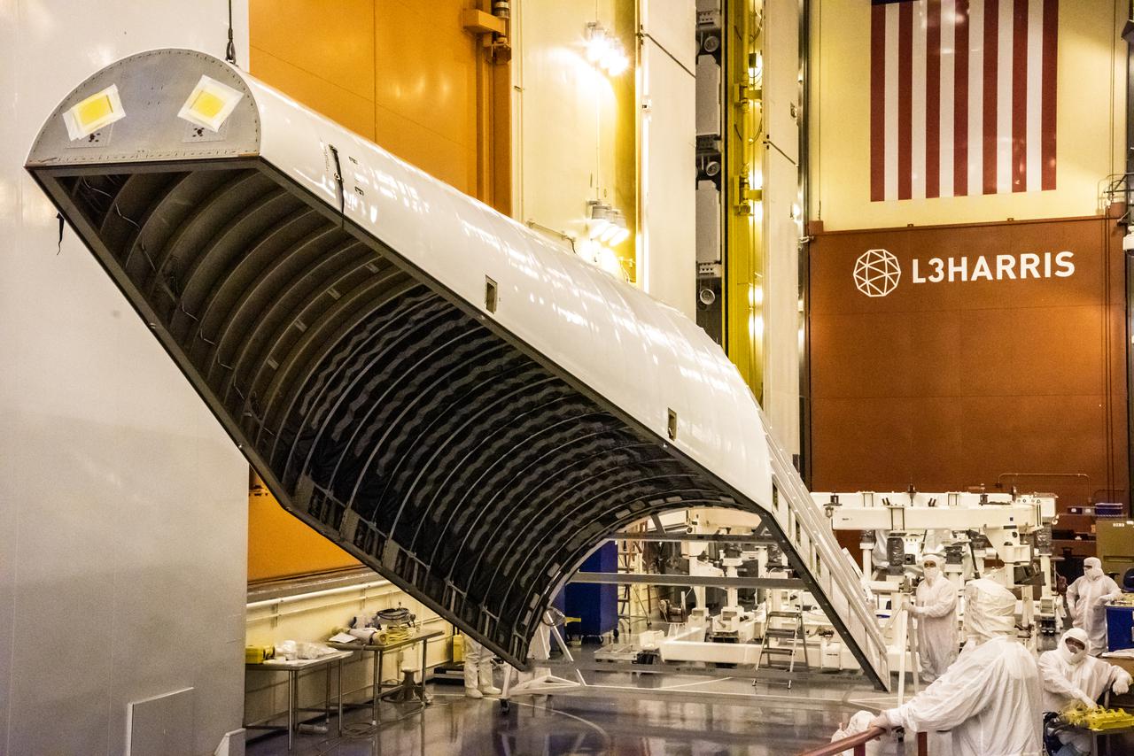 Inside the Integrated Processing Facility at Vandenberg Space Force Base in California, a crane is used to lift the first of two United Launch Alliance Atlas V payload fairings for NASA’s Landsat 9 satellite into the vertical position on June 18, 2021. The fairings will encapsulate the satellite for its launch atop the Atlas V from Vandenberg in September 2021. The launch is being managed by NASA’s Launch Services Program based at Kennedy Space Center in Florida. Landsat 9 will continue the nearly 50-year legacy of previous Landsat missions. It will monitor key natural and economic resources from orbit. Landsat 9 is managed by the agency’s Goddard Space Flight Center in Greenbelt, Maryland. It will carry two instruments: the Operational Land Imager 2, which collects images of Earth’s landscapes in visible, near-infrared and shortwave infrared light, and the Thermal Infrared Sensor 2, which measures the temperature of land surfaces. Like its predecessors, Landsat 9 is a joint mission between NASA and the U.S. Geological Survey.