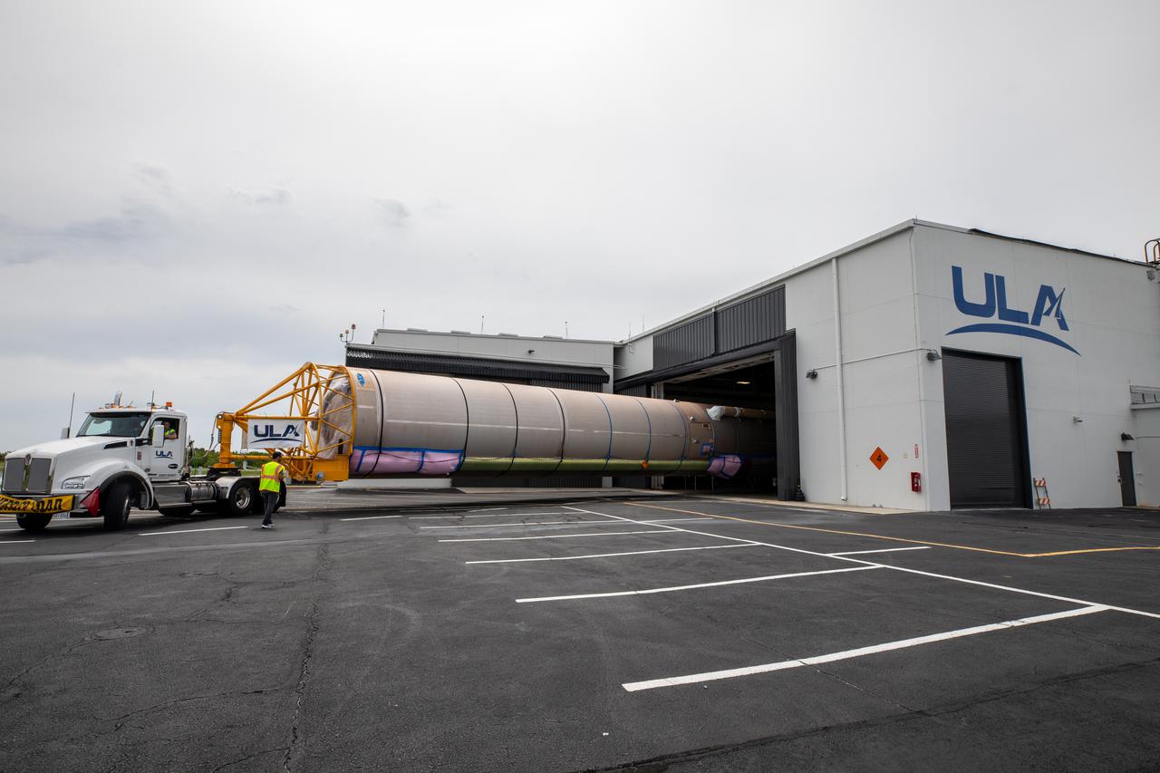 A flatbed truck delivers the United Launch Alliance (ULA) Atlas V booster and Centaur upper stage for Boeing's CST-100 Starliner Crew Flight Test (CFT) to the Atlas Spaceflight Operations Center at Space Launch Complex 41 (SLC-41) at Cape Canaveral Space Force Station on June 21, 2021. Starliner's first flight with astronauts aboard, CFT will launch from SLC-41. The flight test will demonstrate the ability of the Atlas V and Starliner to safely carry astronauts to and from the International Space Station for the agency's Commercial Crew Program.