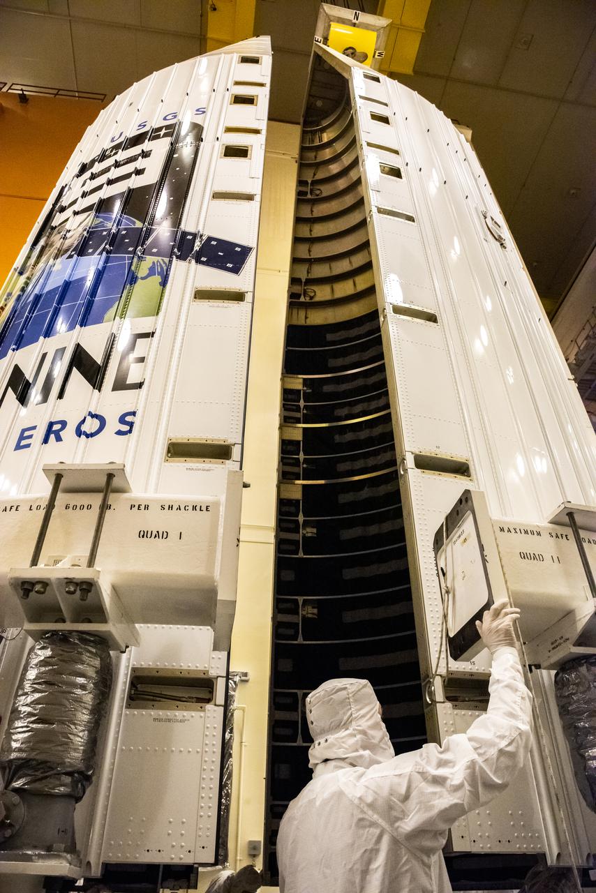 Inside the Integrated Processing Facility at Vandenberg Space Force Base in California, at right, the second half of two United Launch Alliance Atlas V payload fairings for NASA’s Landsat 9 satellite is raised to the vertical position on June 21, 2021. The fairings will encapsulate the satellite for its launch atop the Atlas V from Vandenberg in September 2021. The launch is being managed by NASA’s Launch Services Program based at Kennedy Space Center in Florida. Landsat 9 will continue the nearly 50-year legacy of previous Landsat missions. It will monitor key natural and economic resources from orbit. Landsat 9 is managed by the agency’s Goddard Space Flight Center in Greenbelt, Maryland. It will carry two instruments: the Operational Land Imager 2, which collects images of Earth’s landscapes in visible, near-infrared and shortwave infrared light, and the Thermal Infrared Sensor 2, which measures the temperature of land surfaces. Like its predecessors, Landsat 9 is a joint mission between NASA and the U.S. Geological Survey.
