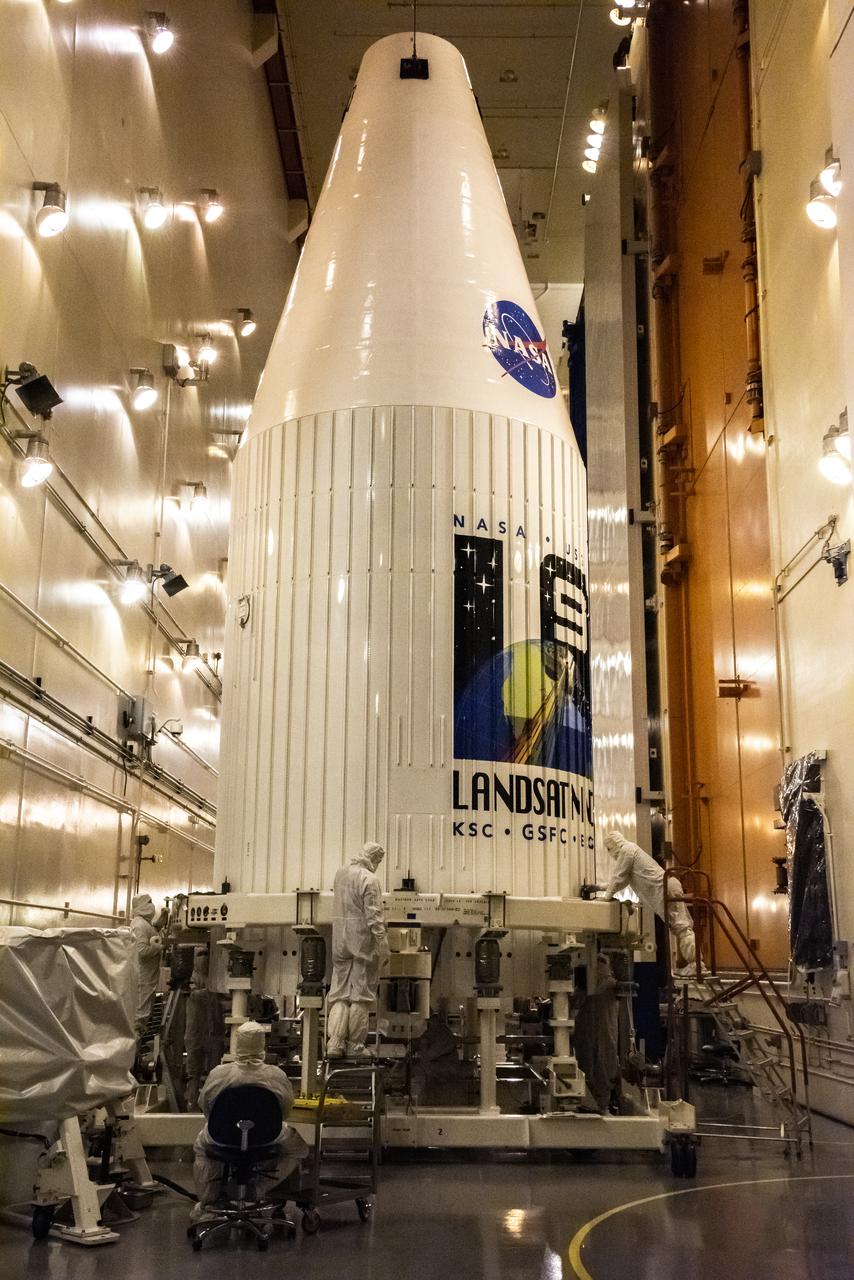 Inside the Integrated Processing Facility at Vandenberg Space Force Base in California, the second half of two United Launch Alliance Atlas V payload fairings for NASA’s Landsat 9 satellite is raised to the vertical position on June 21, 2021. The fairings will encapsulate the satellite for its launch atop the Atlas V from Vandenberg in September 2021. The launch is being managed by NASA’s Launch Services Program based at Kennedy Space Center in Florida. Landsat 9 will continue the nearly 50-year legacy of previous Landsat missions. It will monitor key natural and economic resources from orbit. Landsat 9 is managed by the agency’s Goddard Space Flight Center in Greenbelt, Maryland. It will carry two instruments: the Operational Land Imager 2, which collects images of Earth’s landscapes in visible, near-infrared and shortwave infrared light, and the Thermal Infrared Sensor 2, which measures the temperature of land surfaces. Like its predecessors, Landsat 9 is a joint mission between NASA and the U.S. Geological Survey.